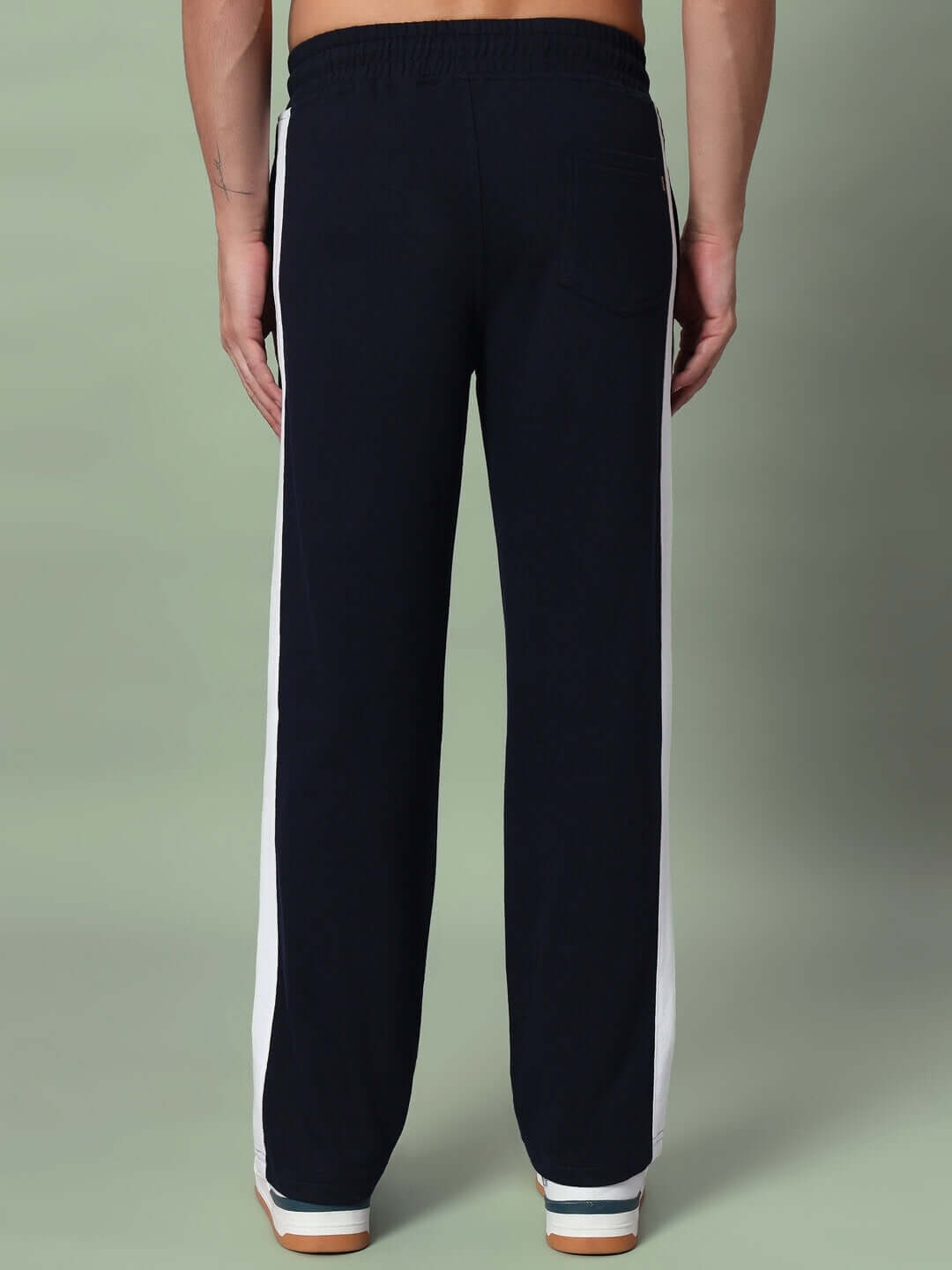 Back view of black FUTURE ICON 2 STRIPE jogger with white side stripes, showing elastic waistband and tailored design by DUDS.