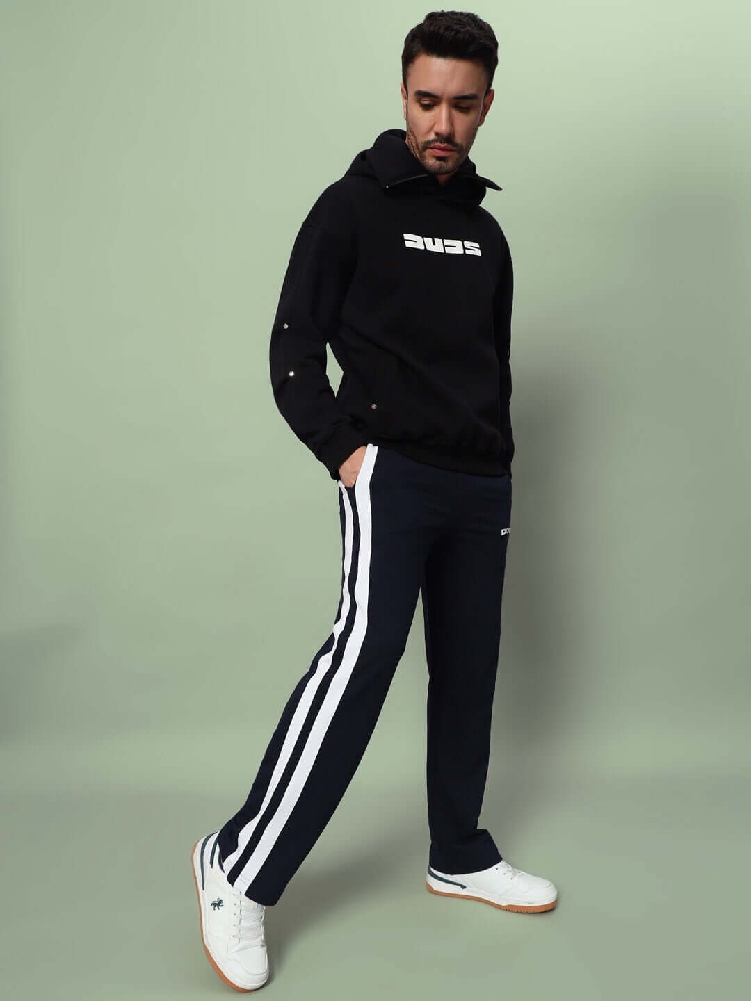 Model wearing black FUTURE ICON 2 STRIPE JOGGER by DUDS, featuring stylish side stripes. Custom fit options available for prepaid orders.
