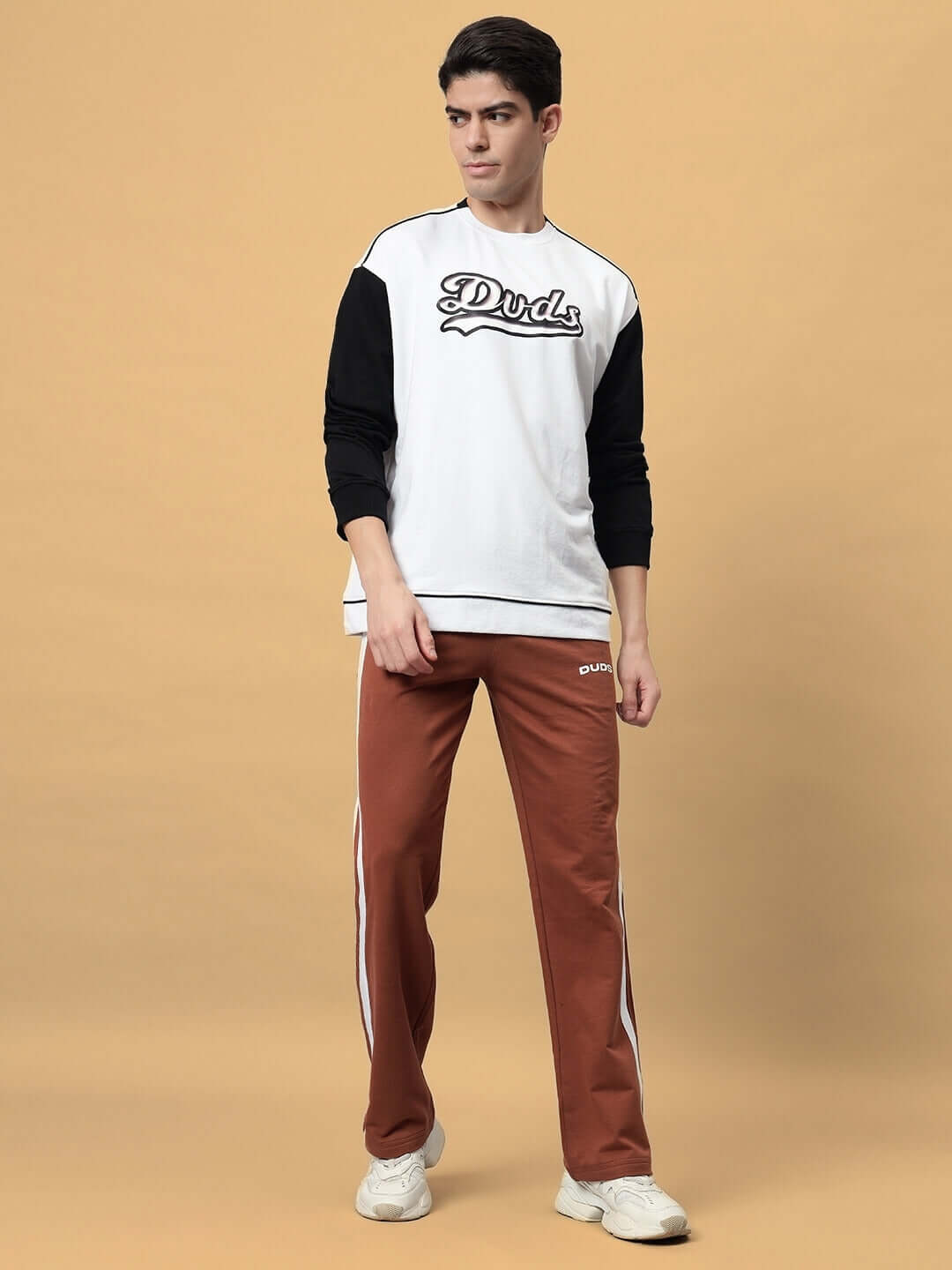 Model wearing Future Icon 2 Stripe Jogger in brown, paired with a white and black Duds top, showcasing casual style and comfort.