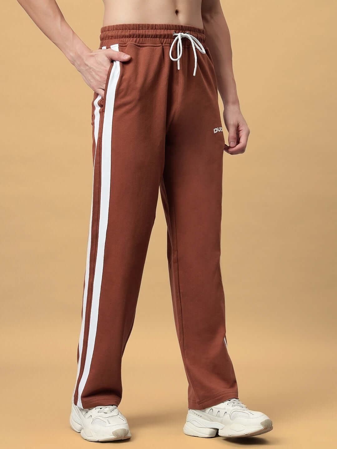 Brown FUTURE ICON 2 STRIPE JOGGER with white side stripes, tailored by DUDS, shown on model wearing white sneakers.