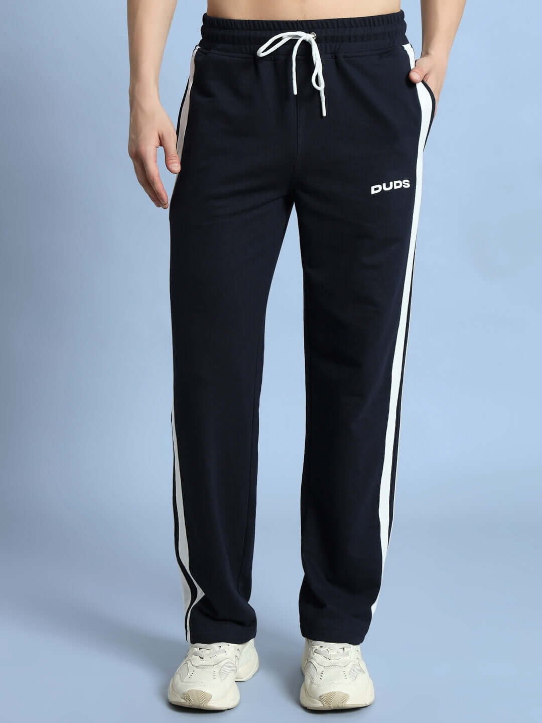 Navy blue jogger pants with white stripes, labeled DUDS, featuring a drawstring waist. Perfect for casual wear and customizable for fit.