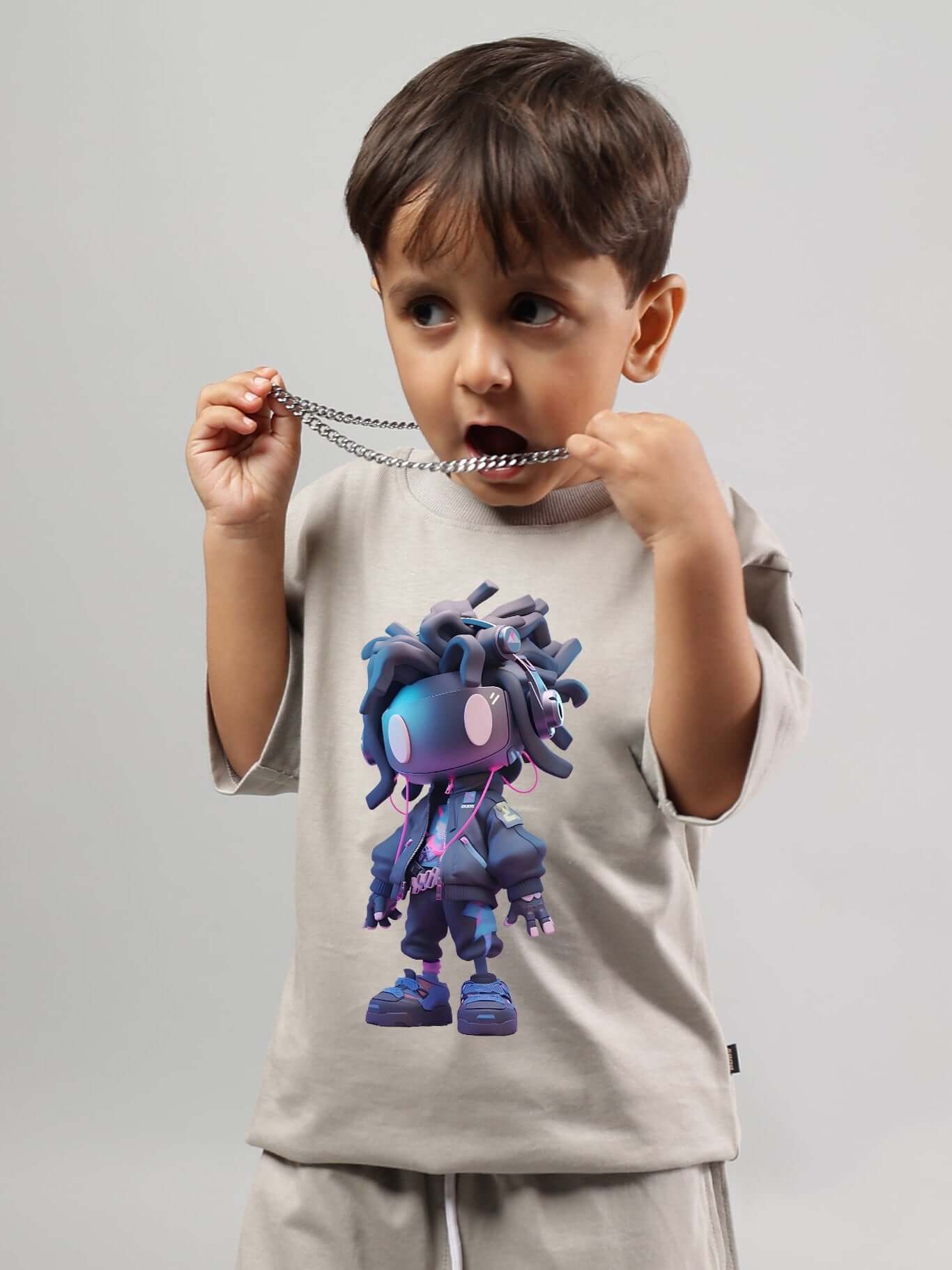 Boy wearing a grey futuristic kids t-shirt with a tech-inspired graphic design.