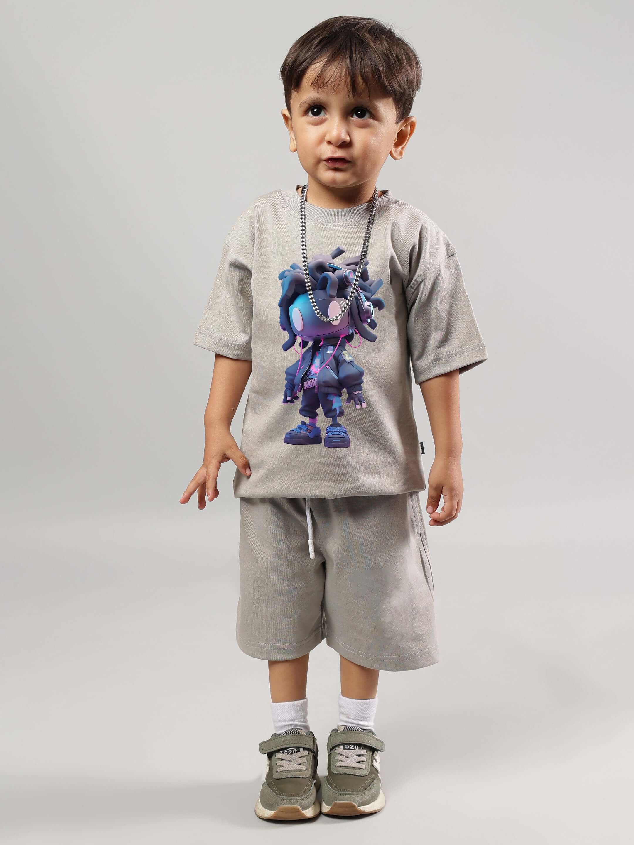 Cute child wearing futuristic grey co-ord set for kids featuring a colorful graphic, perfect for boys & girls. Made to order by DUDS.