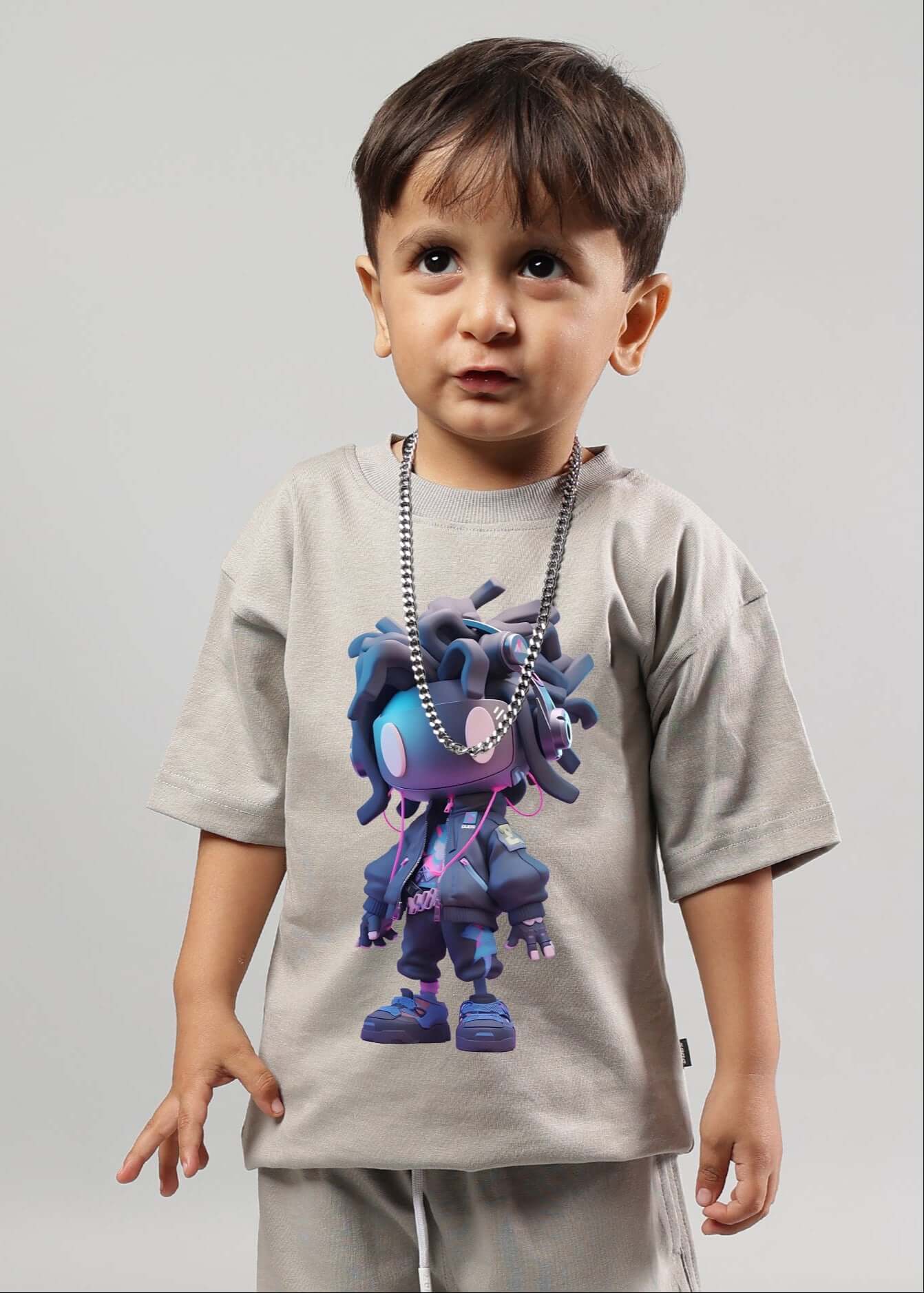 Child wearing grey futuristic kids t-shirt with tech-inspired graphic design.