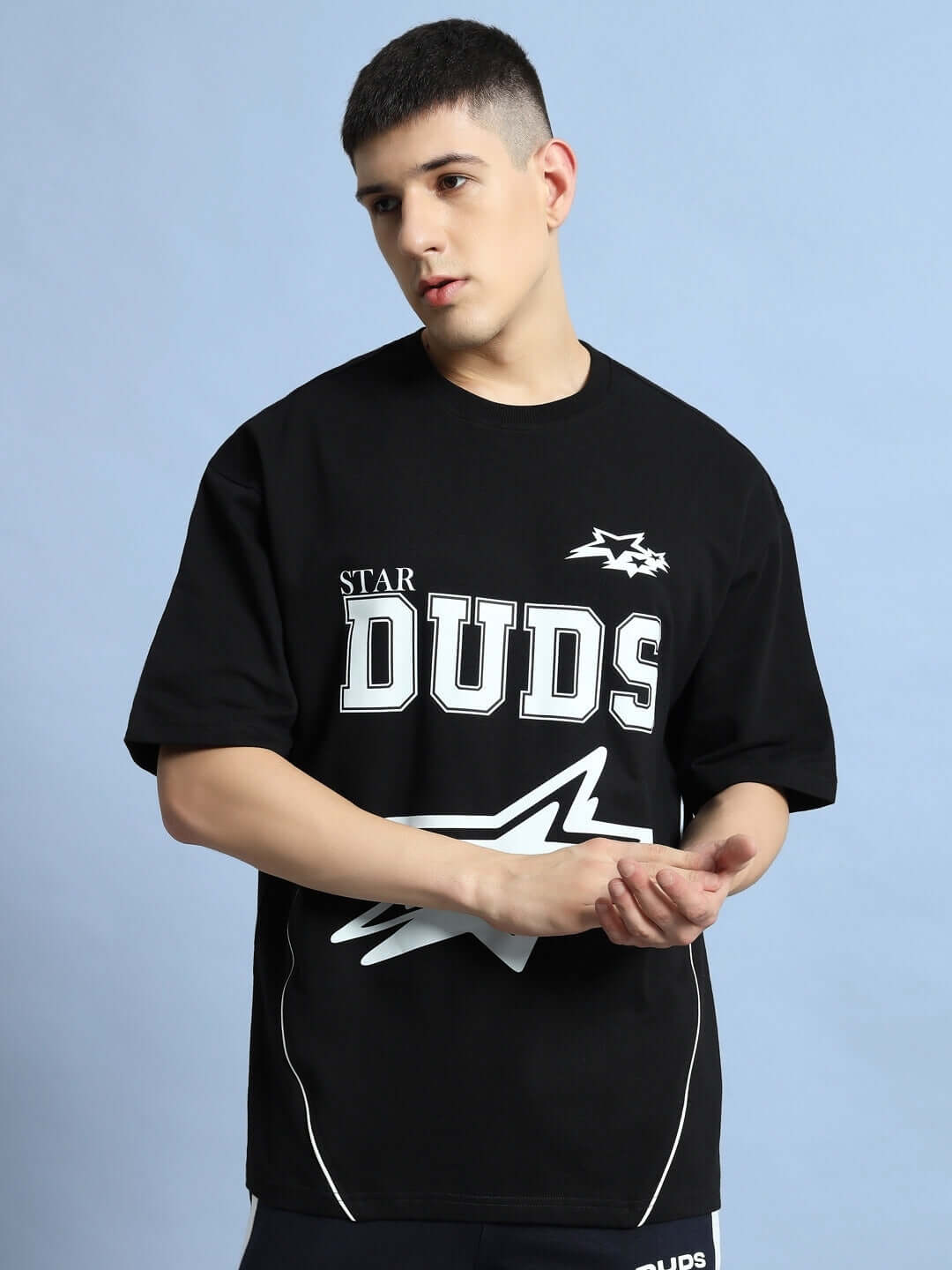 Model wearing a black Galaxy over-sized t-shirt with Star DUDS logo, offering custom fit options for personalized sizing.