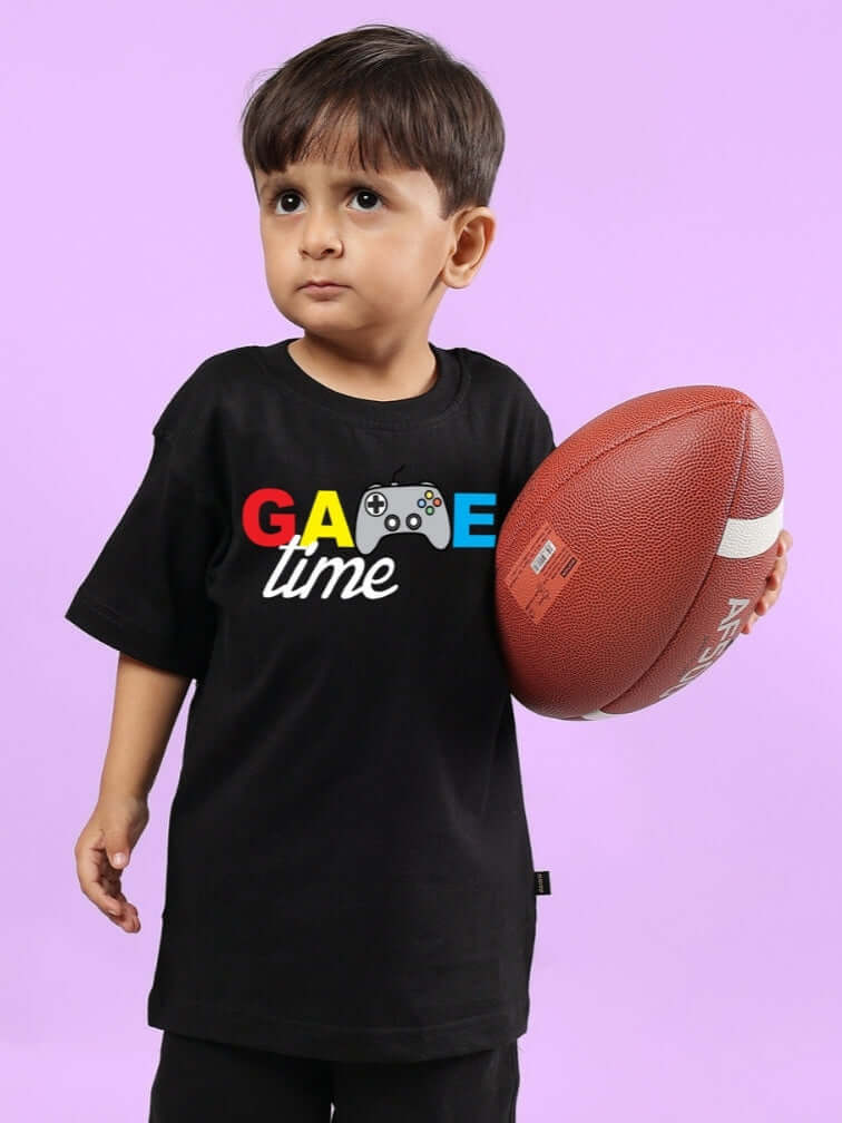 Boy wearing GAME FINISHER T-SHIRT FOR BOYS & GIRLS BLACK holding a football, showcasing sporty style and custom fit options.