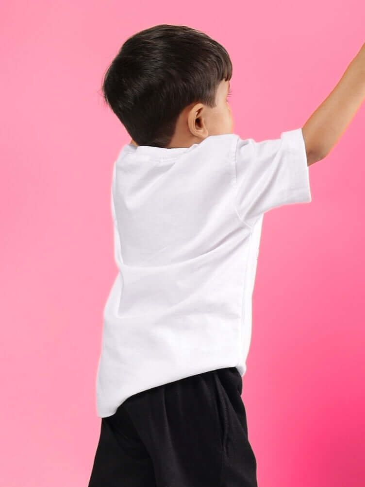 Back view of child wearing GAME TIME T-SHIRT FOR BOYS GIRLS WHITE, against pink background.