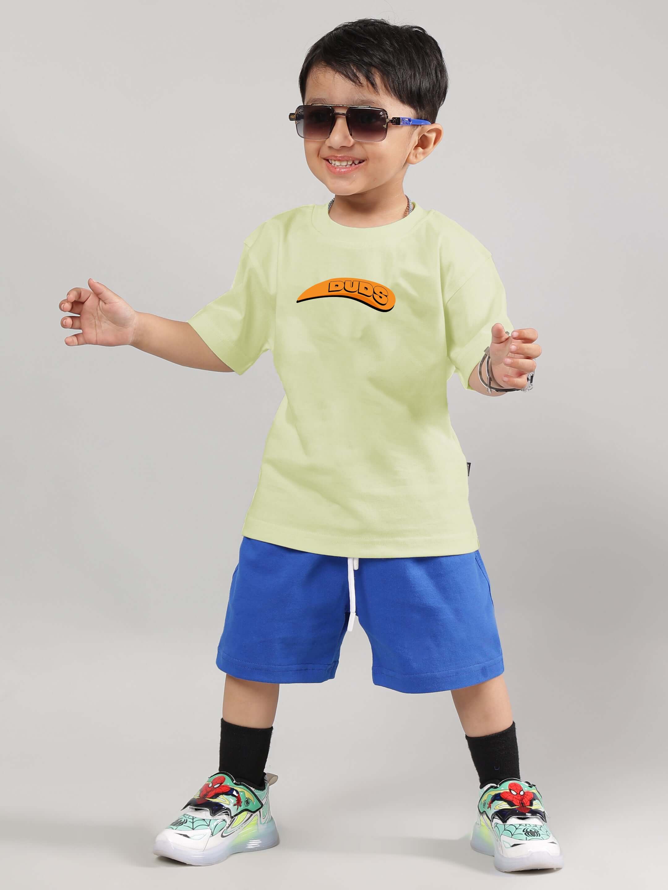 Child wearing Garfield-themed celery t-shirt and blue shorts, part of the Co-ord set for boys and girls by DUDS.