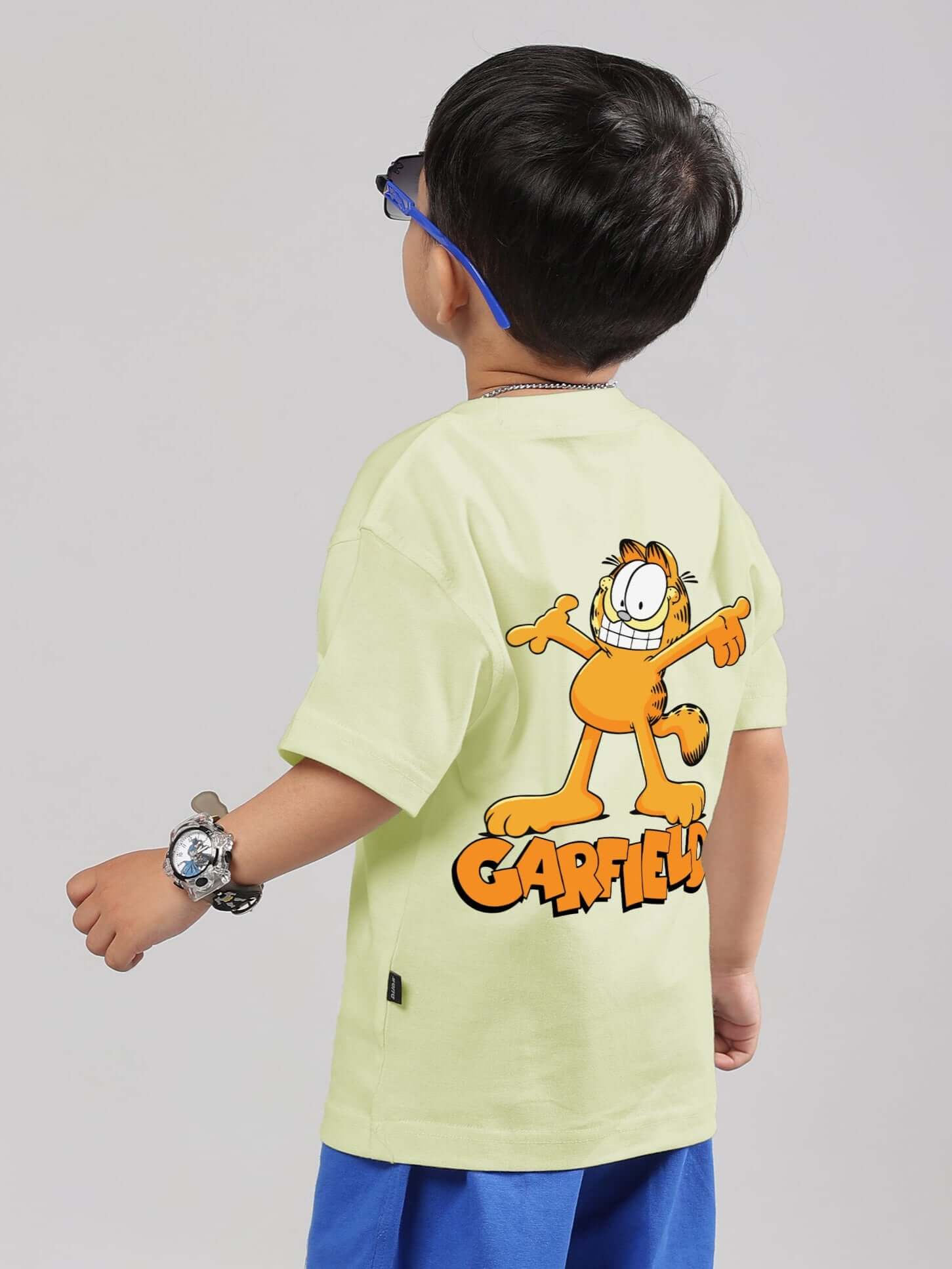 Child wearing a celery-ice Garfield T-shirt showcasing a playful design, ideal for boys and girls. Made to order with customizable fit options.