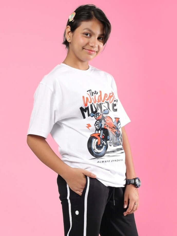 Child wearing GIXXER T-SHIRT FOR BOYS GIRLS WHITE, showcasing stylish unisex design on pink background.