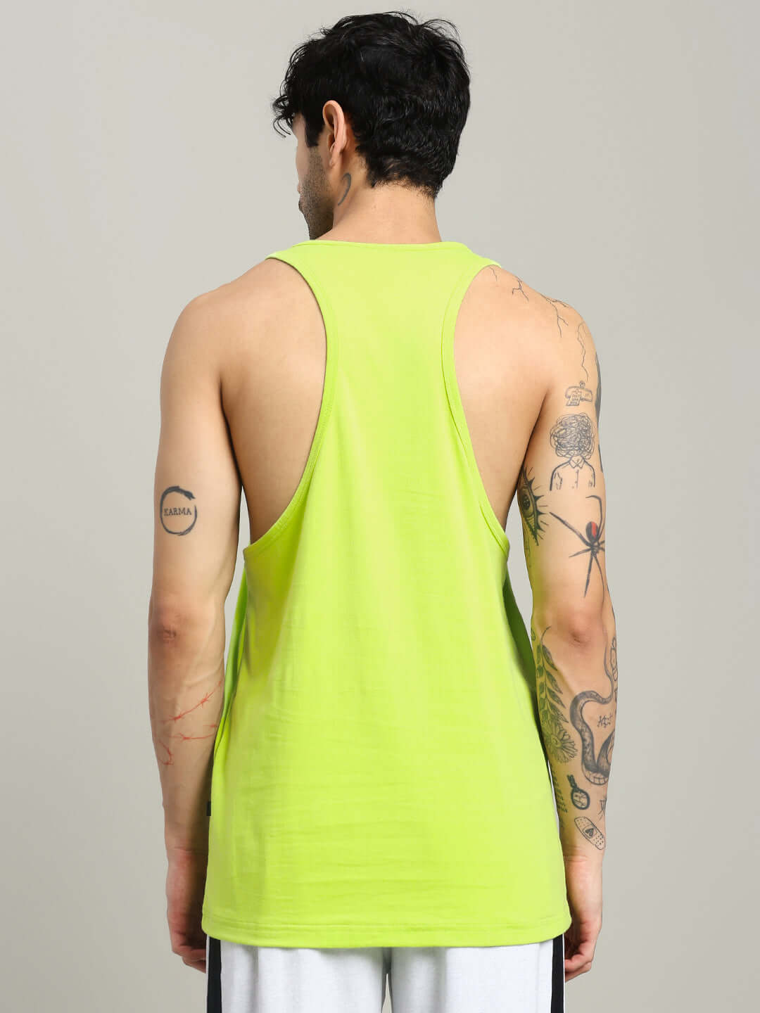 Back view of a person wearing a neon green Gladiator Gym T-shirt showcasing racerback design, perfect for workouts and fitness sessions.