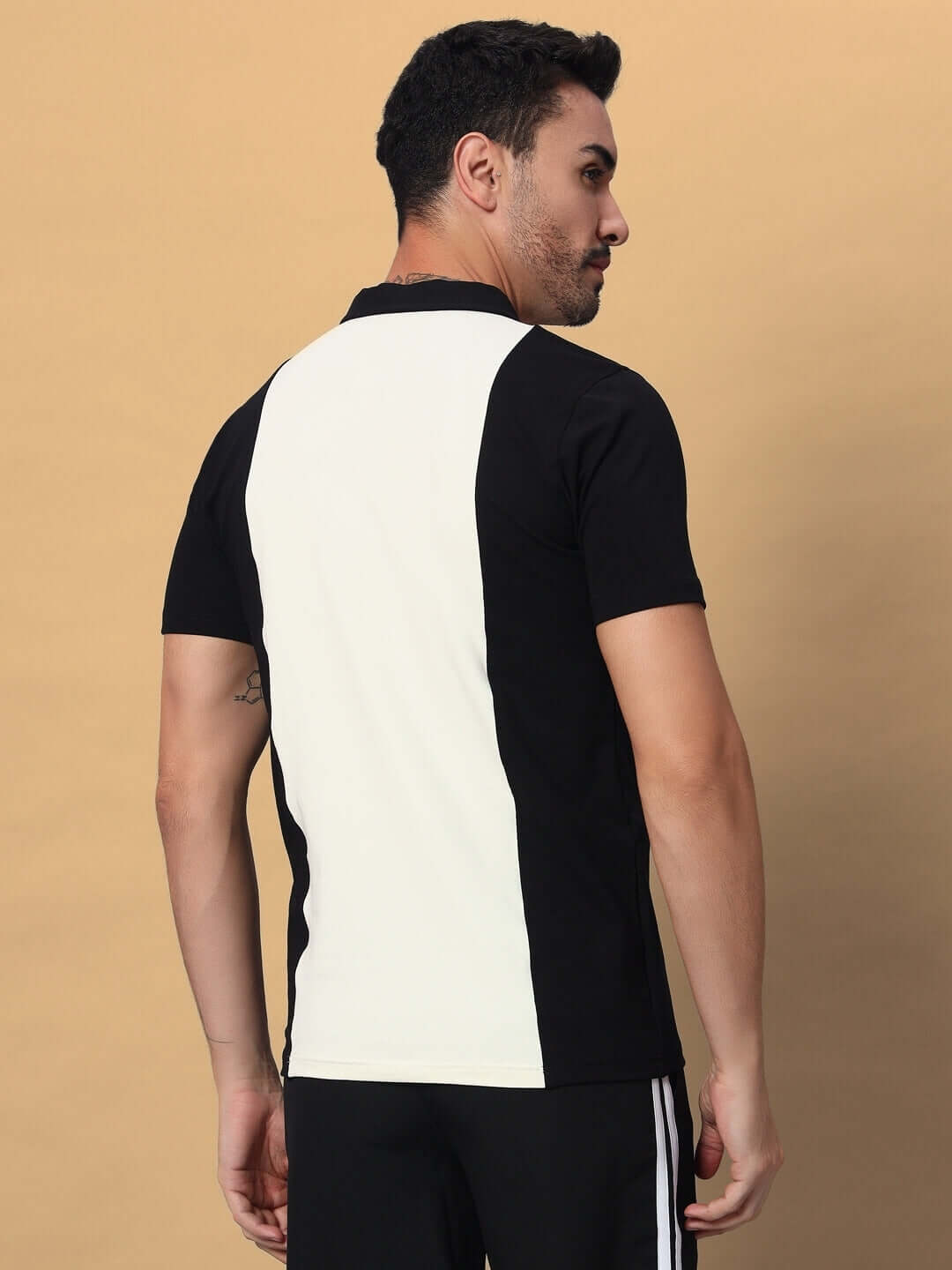 Back view of a man wearing a black and off-white GLORY regular fit T-shirt made of premium cotton French terry lycra blend.