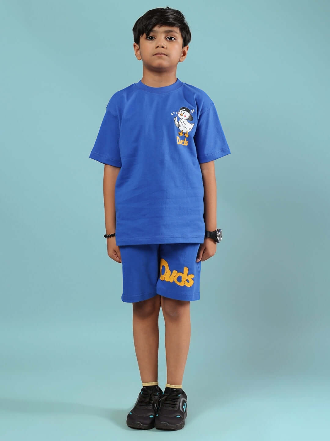 Child wearing blue GO MOTION CO-ORD set for boys & girls by DUDS, featuring a comfortable t-shirt and shorts ensemble.