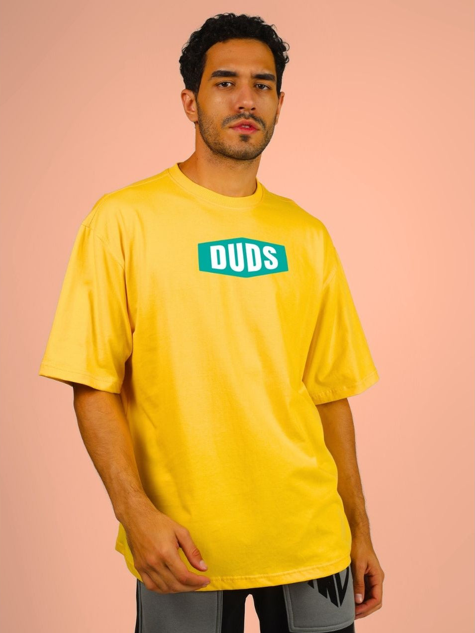 Model wearing the GO WILD ADVENTURE OVER-SIZED T-SHIRT YELLOW with a relaxed fit, showcasing the casual style.