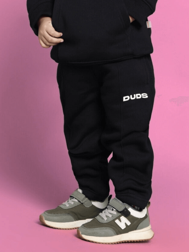Child wearing black Gohan Co-ord for Boys Girls with Duds logo on pants and sneakers, showcasing stylish and comfortable unisex outfit.