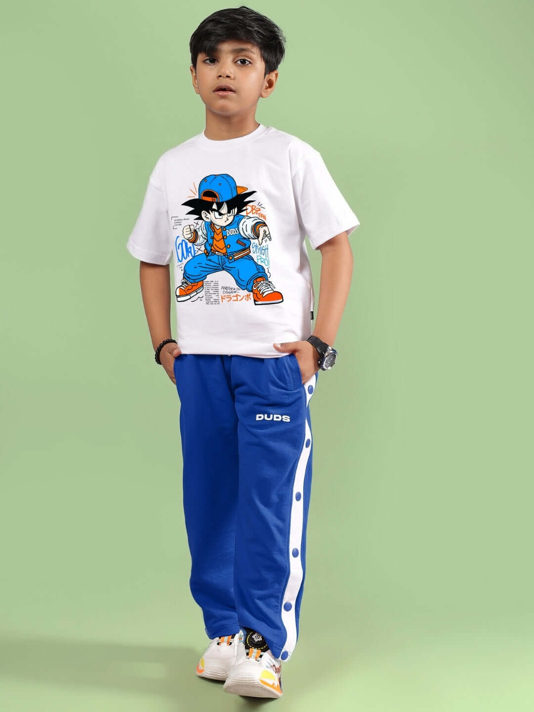 Boy wearing Goku Warrior Co-ord set in white and blue from DUDS, featuring a graphic tee and jogger pants, perfect for kids.