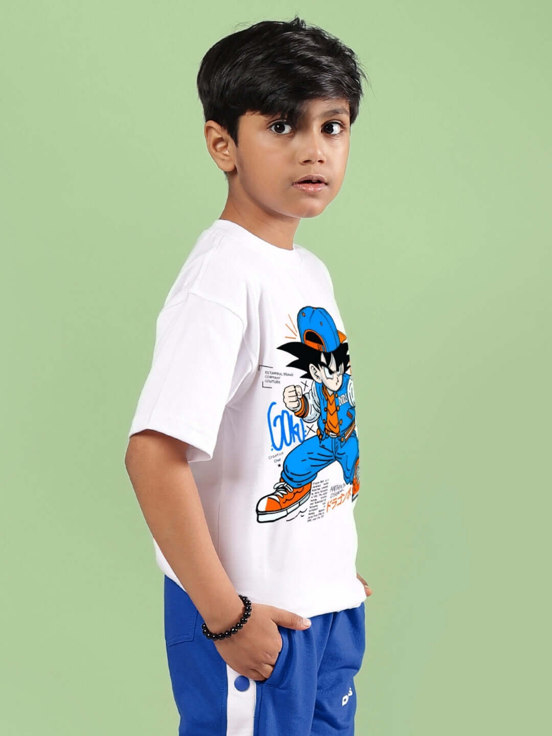 Child wearing GOKU WARRIOR T-SHIRT FOR BOYS & GIRLS WHITE, featuring a vibrant cartoon print, suitable for casual wear.