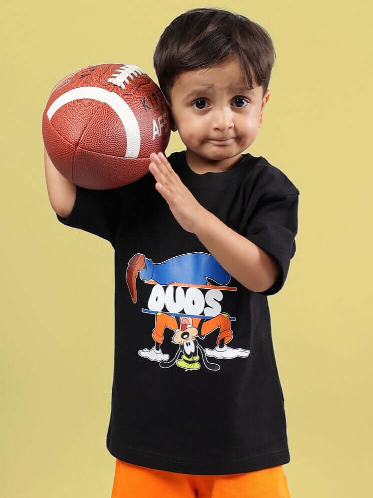 Child wearing GOOFY OVERSIZED T-SHIRT FOR BOYS GIRLS BLACK holding a football