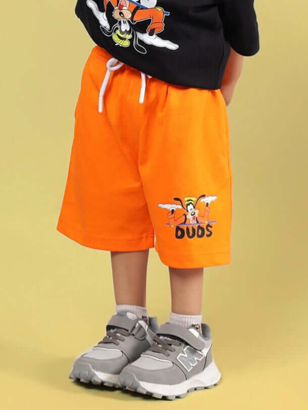 Child wearing orange Goofy shorts by DUDS, featuring playful design for boys and girls, customized options available.