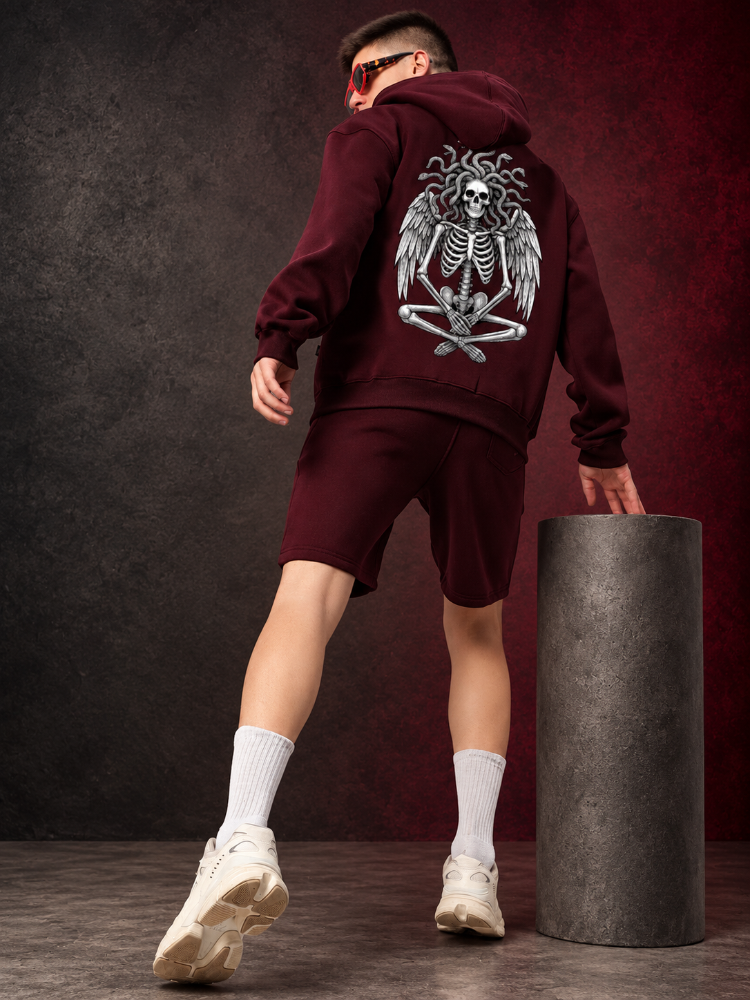 GORGON SKULL PRINTED FLEECE CO-ORD SET WINE worn by model showing bold skull graphic on fleece hoodie and shorts