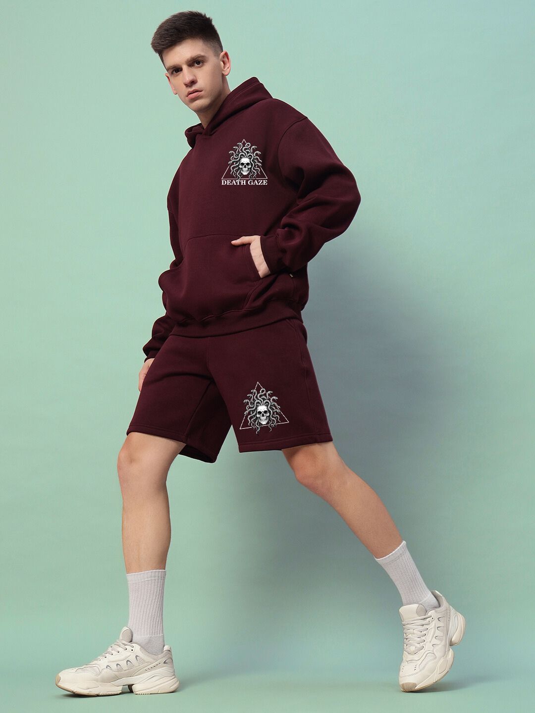 Model wearing GORGON SKULL PRINTED FLEECE CO-ORD SET WINE showcasing streetwear fashion