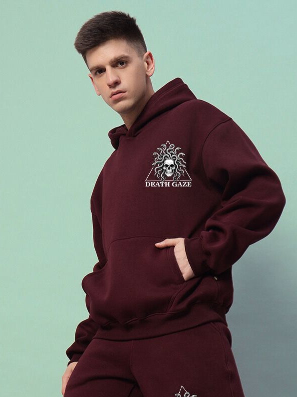 GORGON SKULL PRINTED FLEECE HOODIE WINE worn by model showcasing mythic skull design and rich wine color.