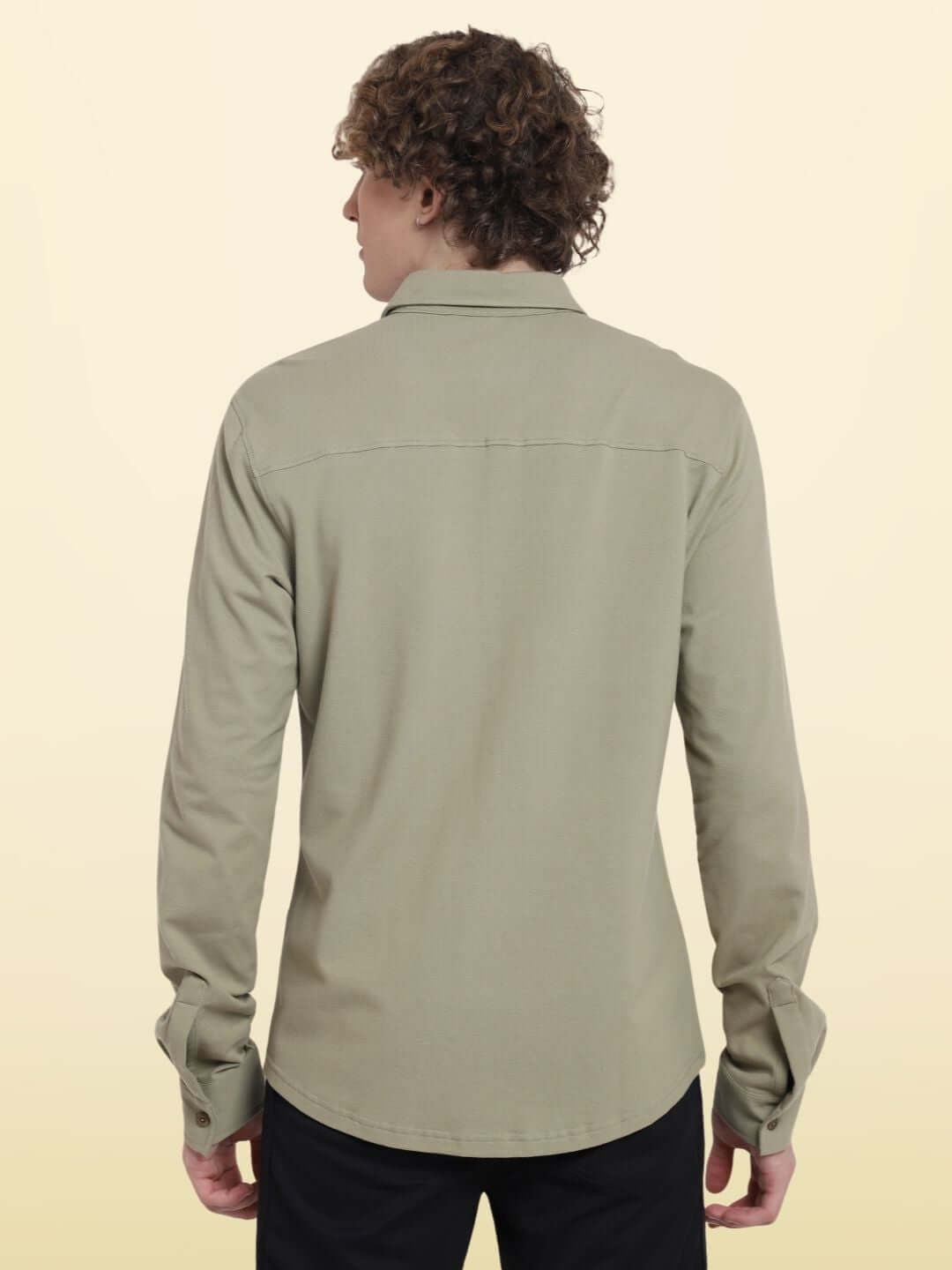 Back view of GRAVEL SPORTY PIQUE SHIRT in full sleeve, wrinkle-free, curved hem; model height 6 feet wearing large size, slim fit design.