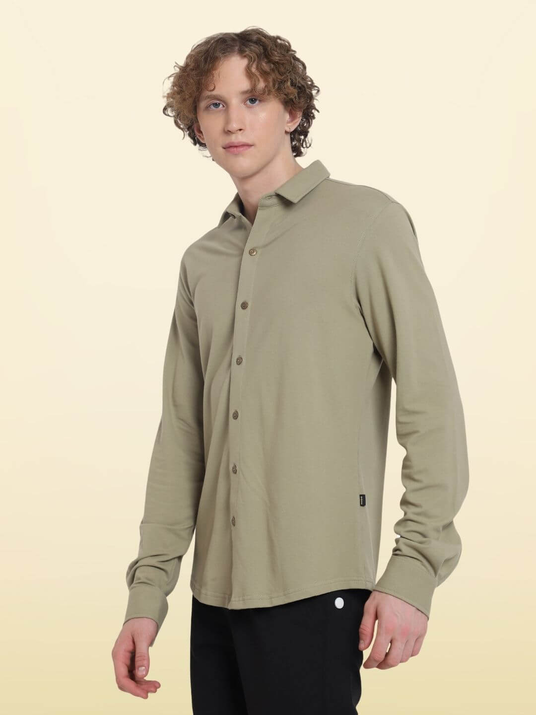 GRAVEL Sporty Pique Shirt, full sleeve, slim fit, wrinkle-free, curved hem, in khaki, modeled by a person standing, sporty and stylish.