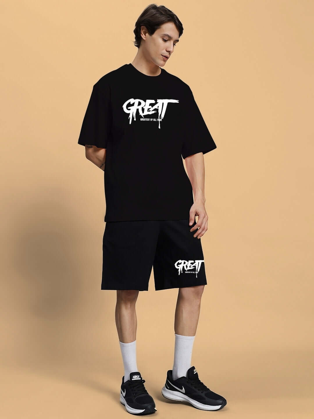 Man wearing GREAT PRINTED SUMMER CO-ORD SET BLACK with stylish graphic logo on premium fabric.