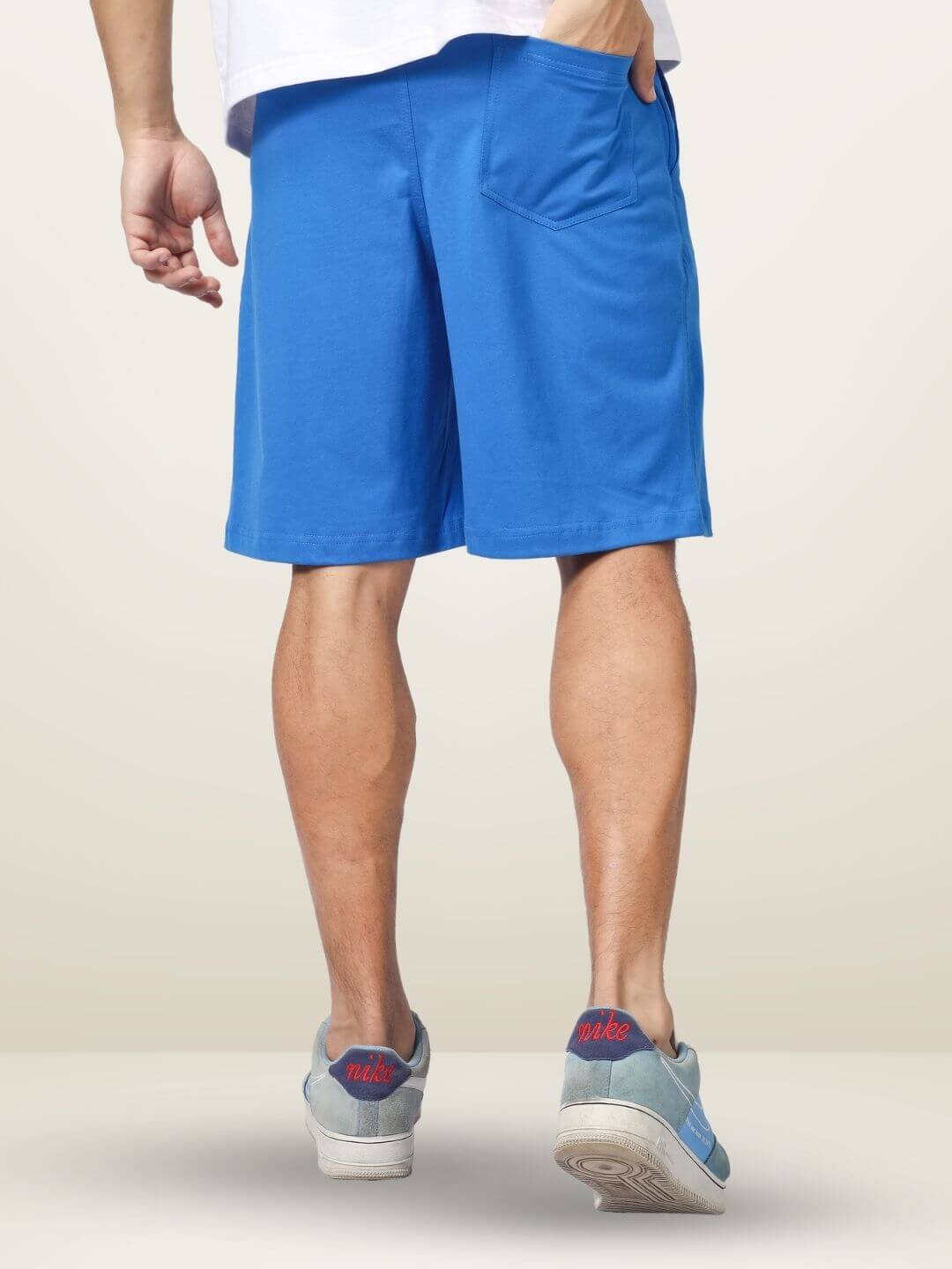 Back view of man wearing The Great Wave blue regular fit shorts, highlighting casual style and comfort. Available in custom fit.