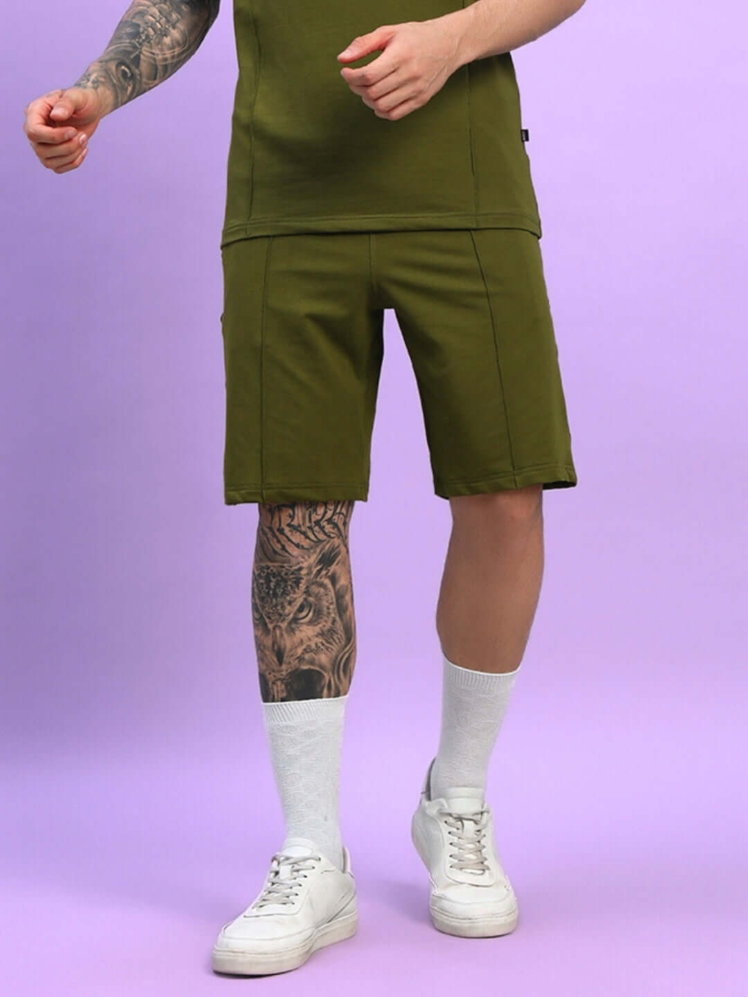 Model wearing Greeble olive green summer shorts, customizable fit with white socks and sneakers, showcasing the trendy style.