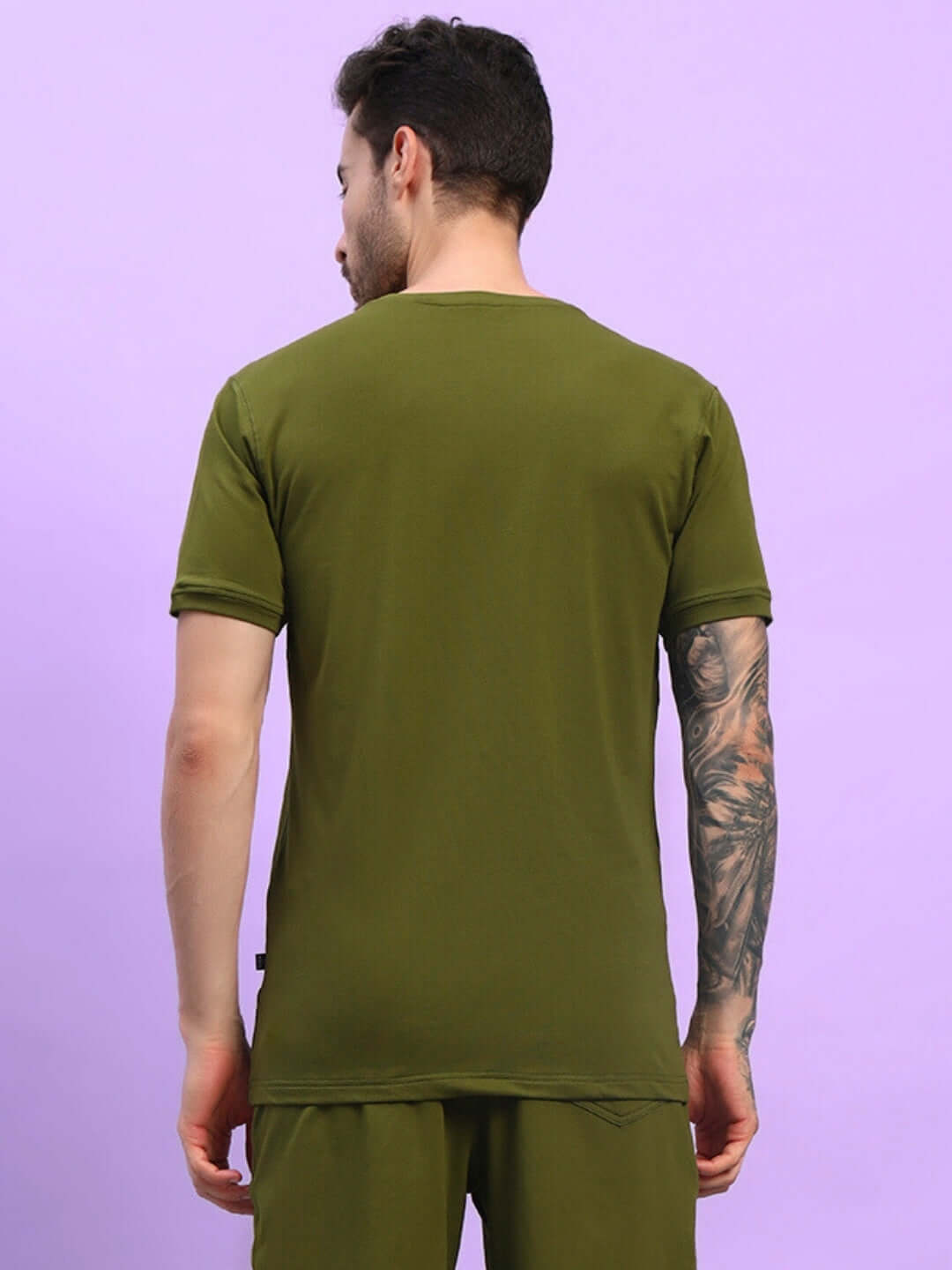 Man wearing olive green regular fit t-shirt, back view. Perfect summer style with breathable cotton material for comfort.