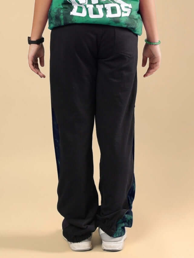 Back view of child wearing green zipper panel jogger pants for boys and girls, comfortable and stylish design by DUDS.