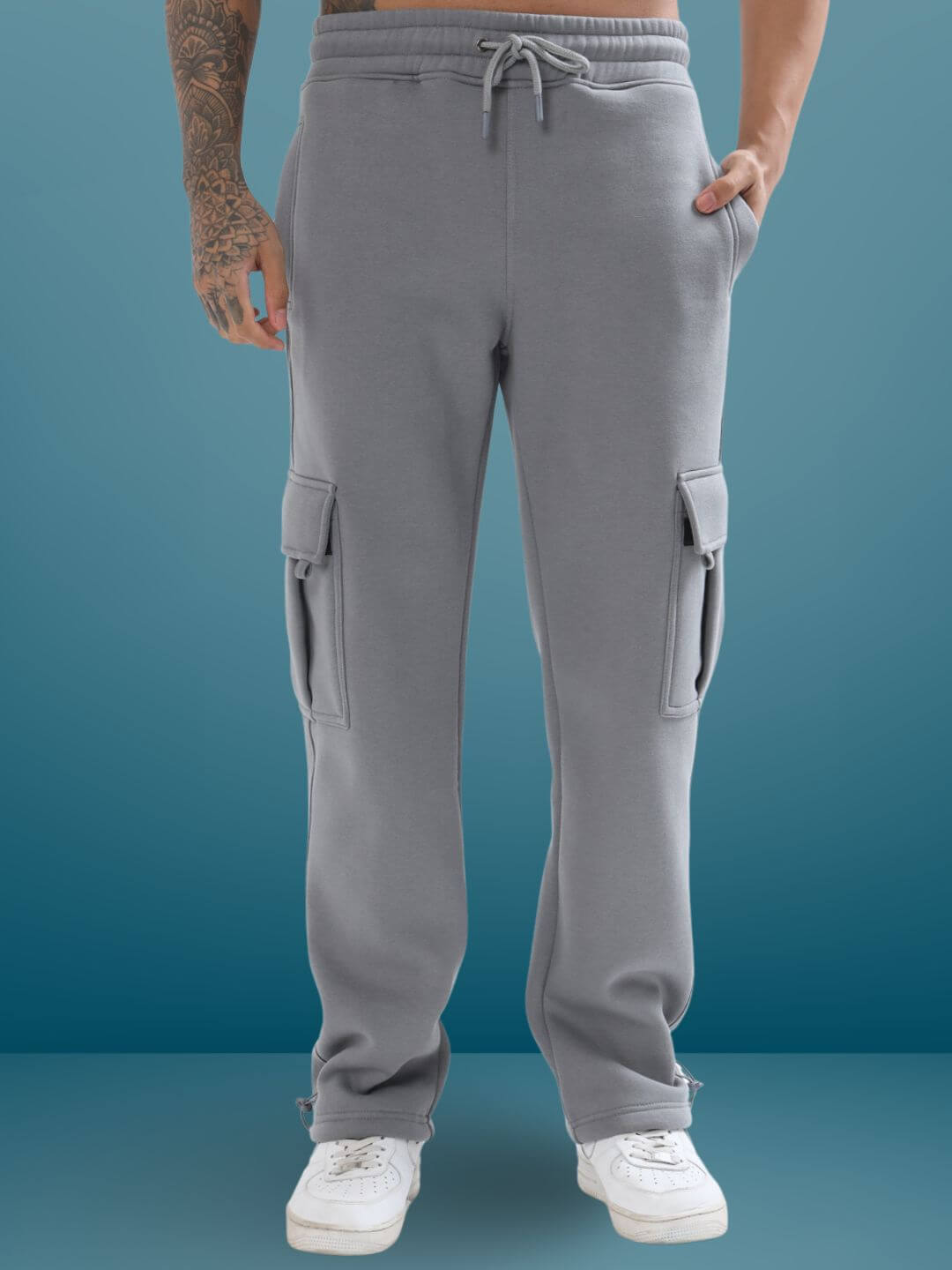 Grey relaxed fit cargo pants with pockets, worn by model, made to order by DUDS experienced tailors, customizable size available.