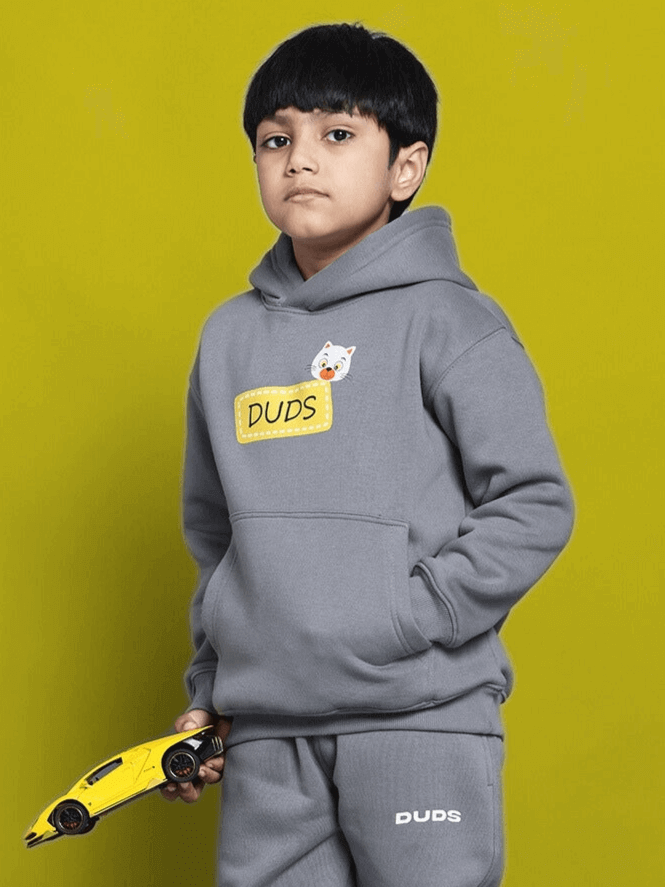 Young boy wearing Tabby Fleece Co-Ord for Boys Girls Grey holding a toy car, showcasing a casual and comfy unisex outfit