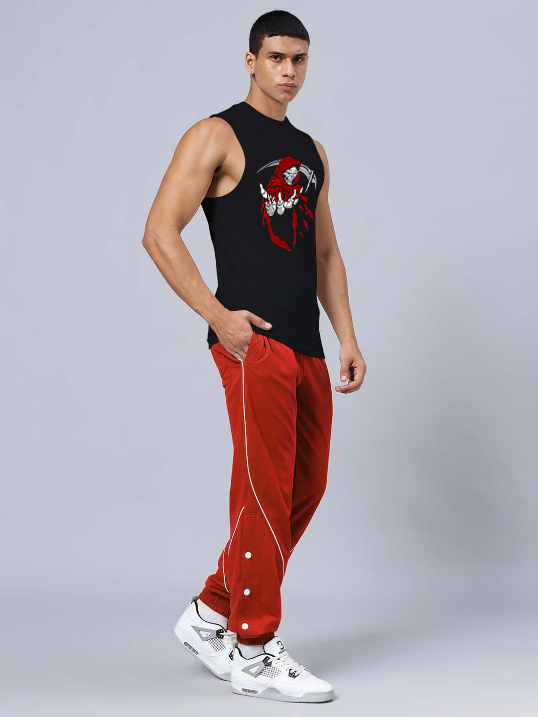 Man wearing GRIM REAPER PRINTED GYM RELAXED FIT CO-ORD SET BLACK-RED with elasticated joggers and sleeveless top.