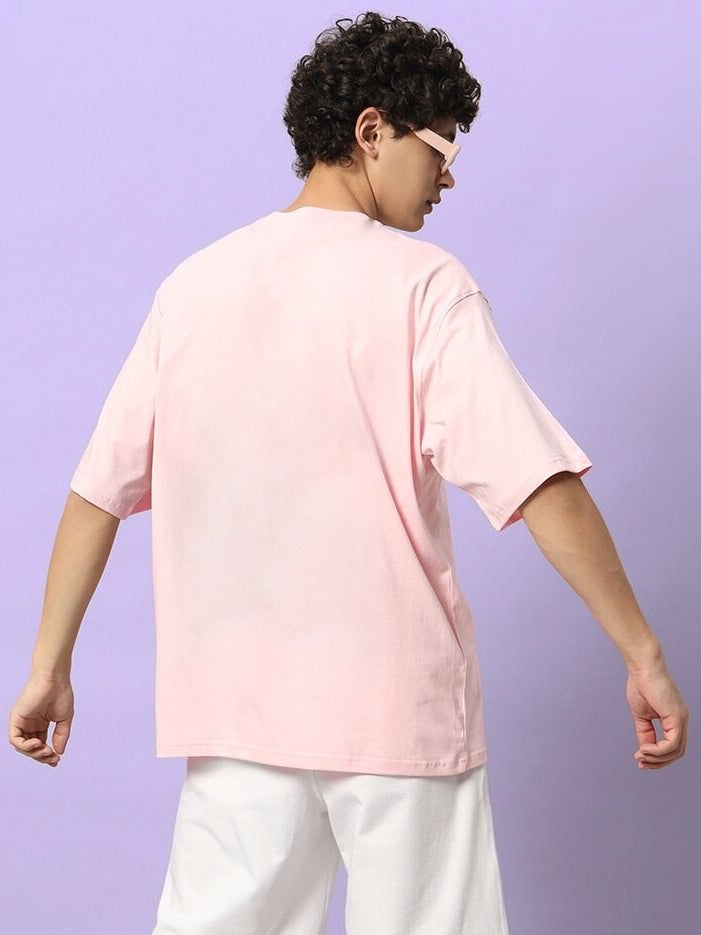 Man wearing a HAPPY INTERESTING OVERSIZED T-SHIRT PINK with purple background