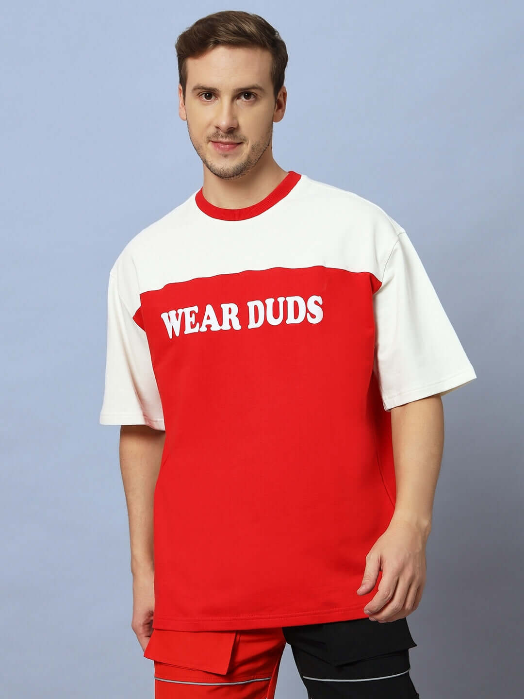 Red and off-white Harlem oversized t-shirt made of premium cotton, shown on model, featuring "Wear Duds" text, ideal for casual wear.
