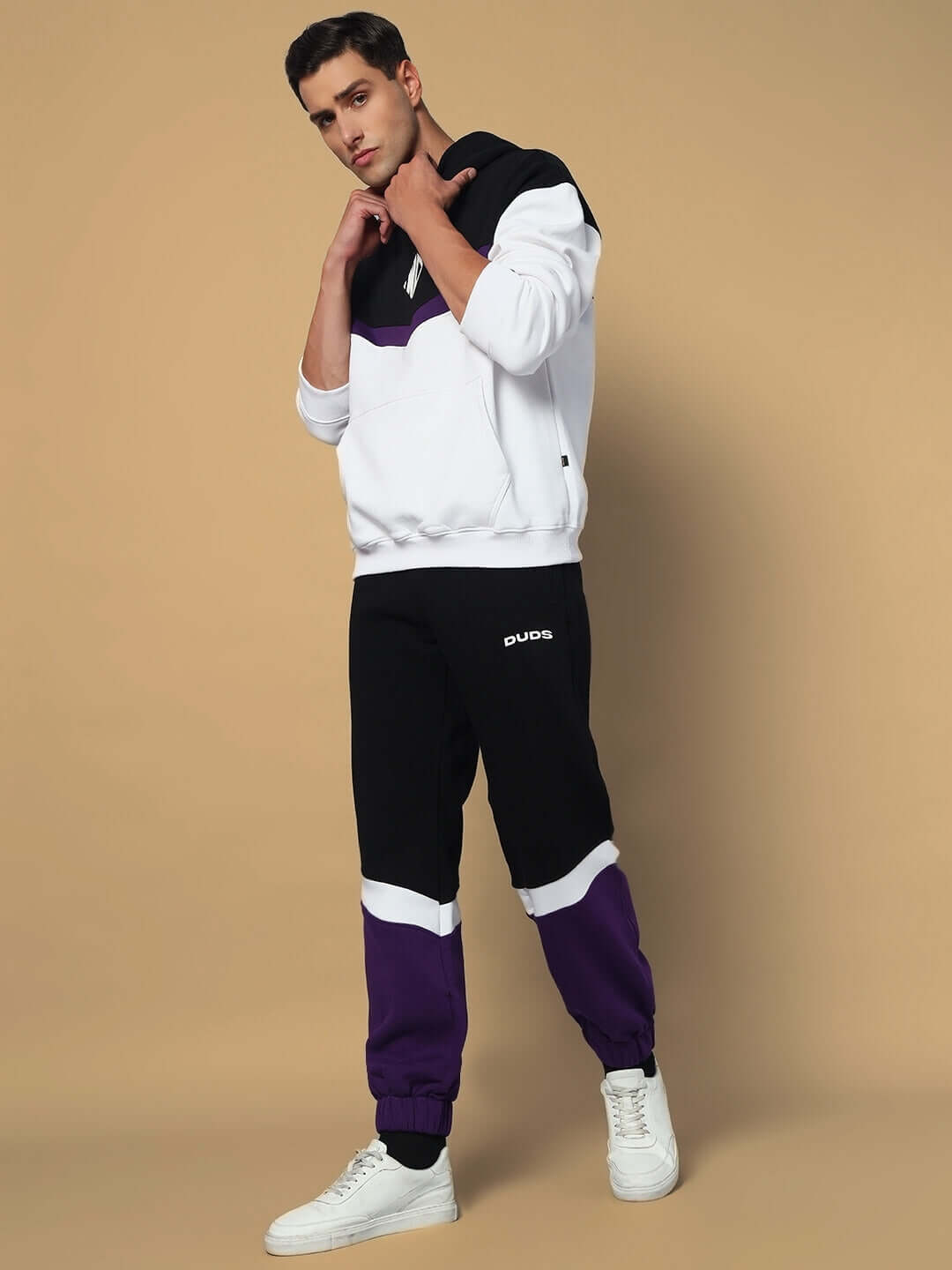 Man wearing HARLEY FLEECE COLORBLOCK HOODIE WHITE PURPLE, showcasing trendy streetwear style.