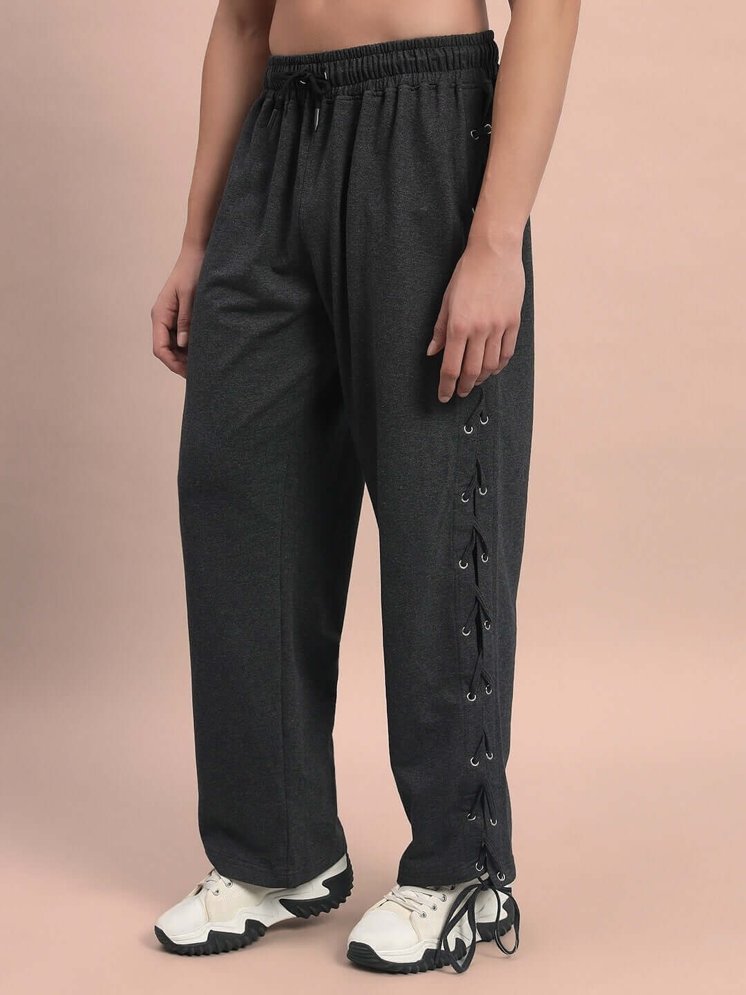 Person wearing Hazel Relaxed Fit Joggers in grey with lace-up detail, paired with white sneakers.