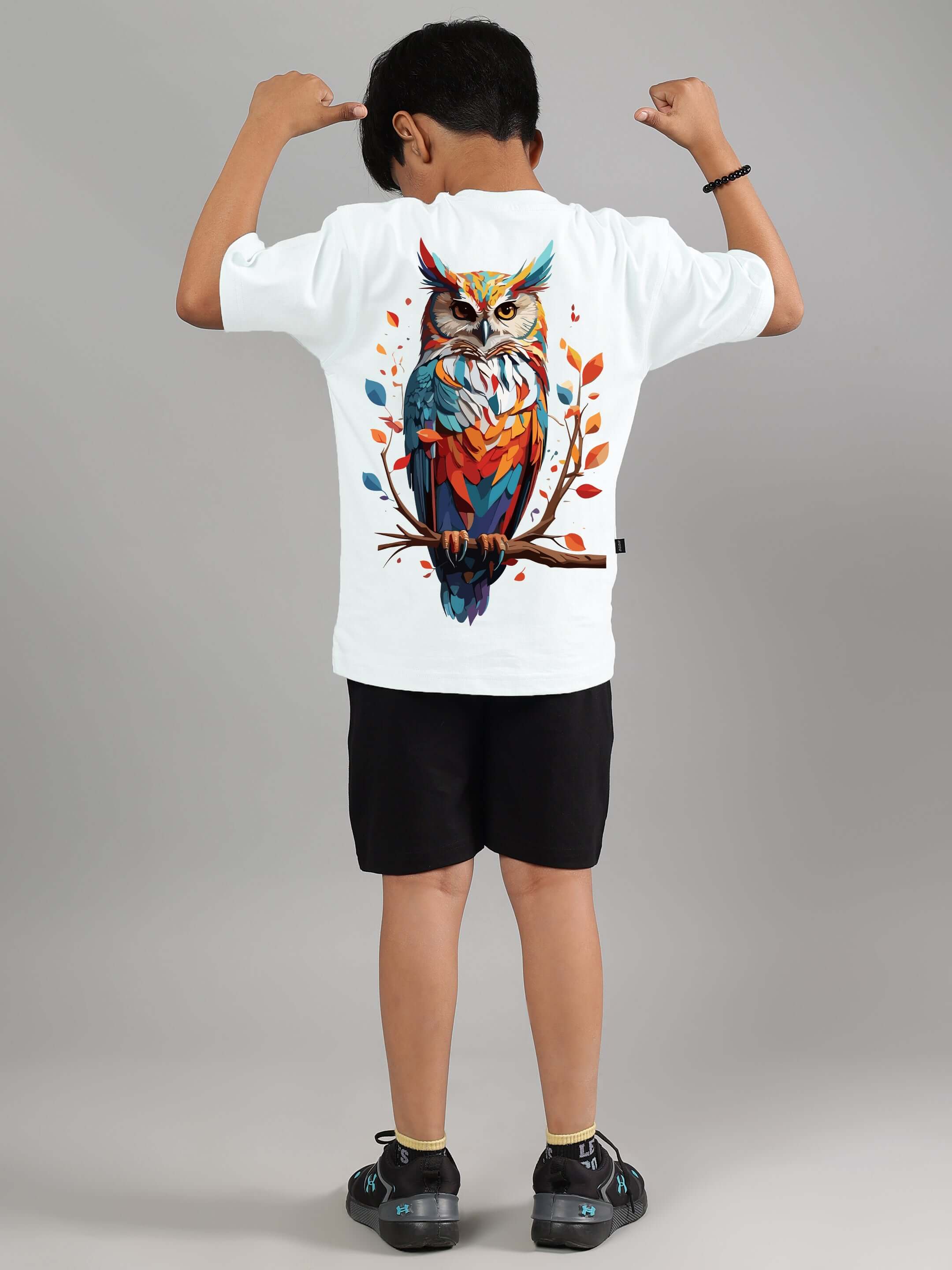 Child wearing a white Hedwig Co-ord set with colorful owl graphic, showcasing back view. Suitable for boys and girls, custom size available.