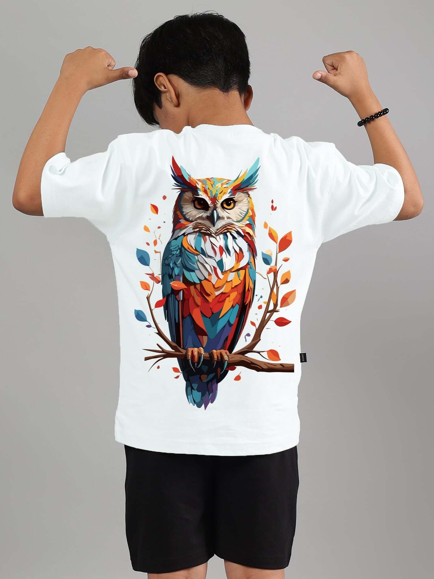 Child wearing white Hedwig t-shirt featuring colorful owl design, showcasing back graphic for boys and girls.