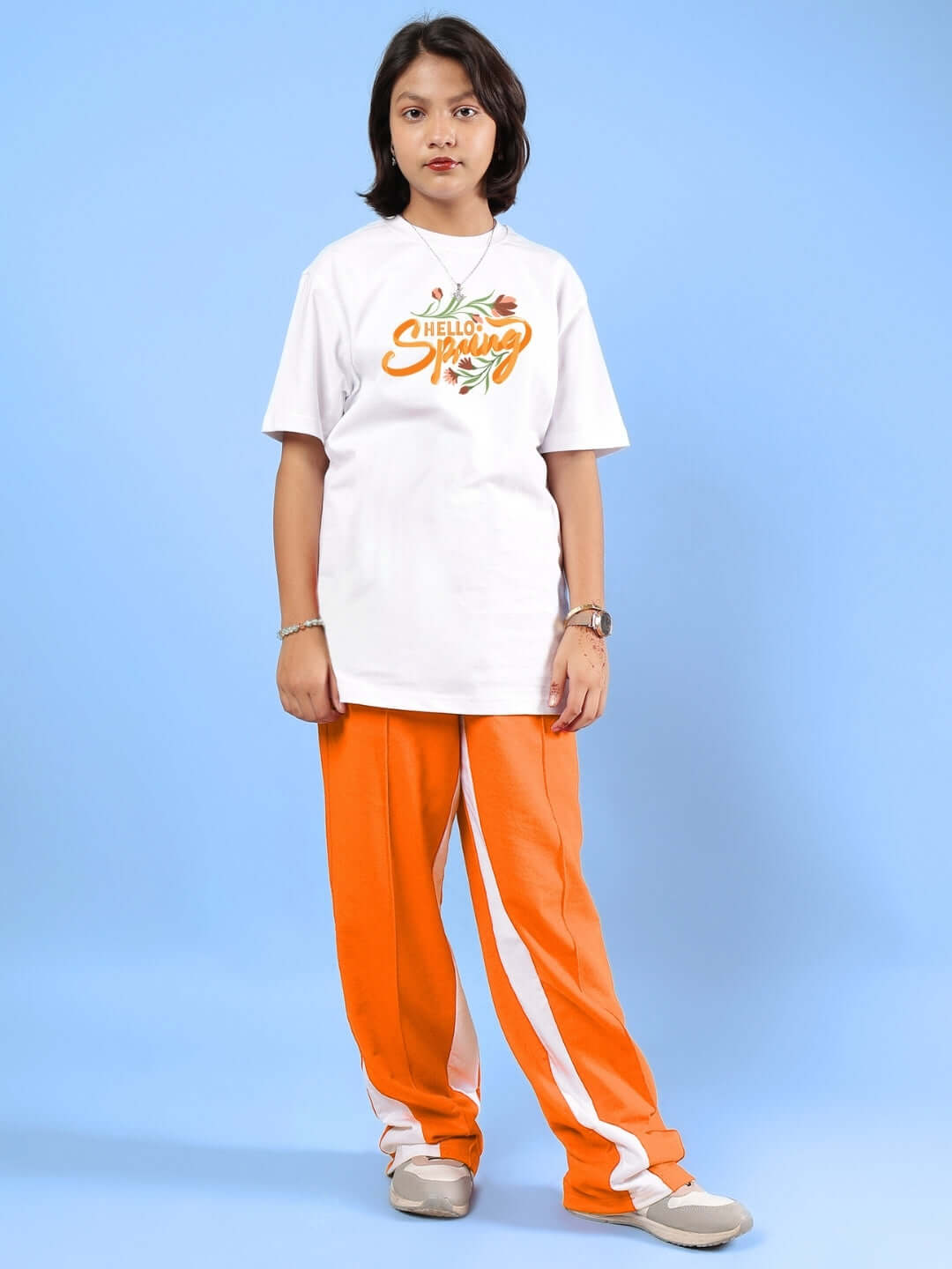 Child wearing HELLO SPRING CO-ORD FOR BOYS & GIRLS WHITE-ORANGE from DUDS, showcasing comfortable and stylish design for all seasons.