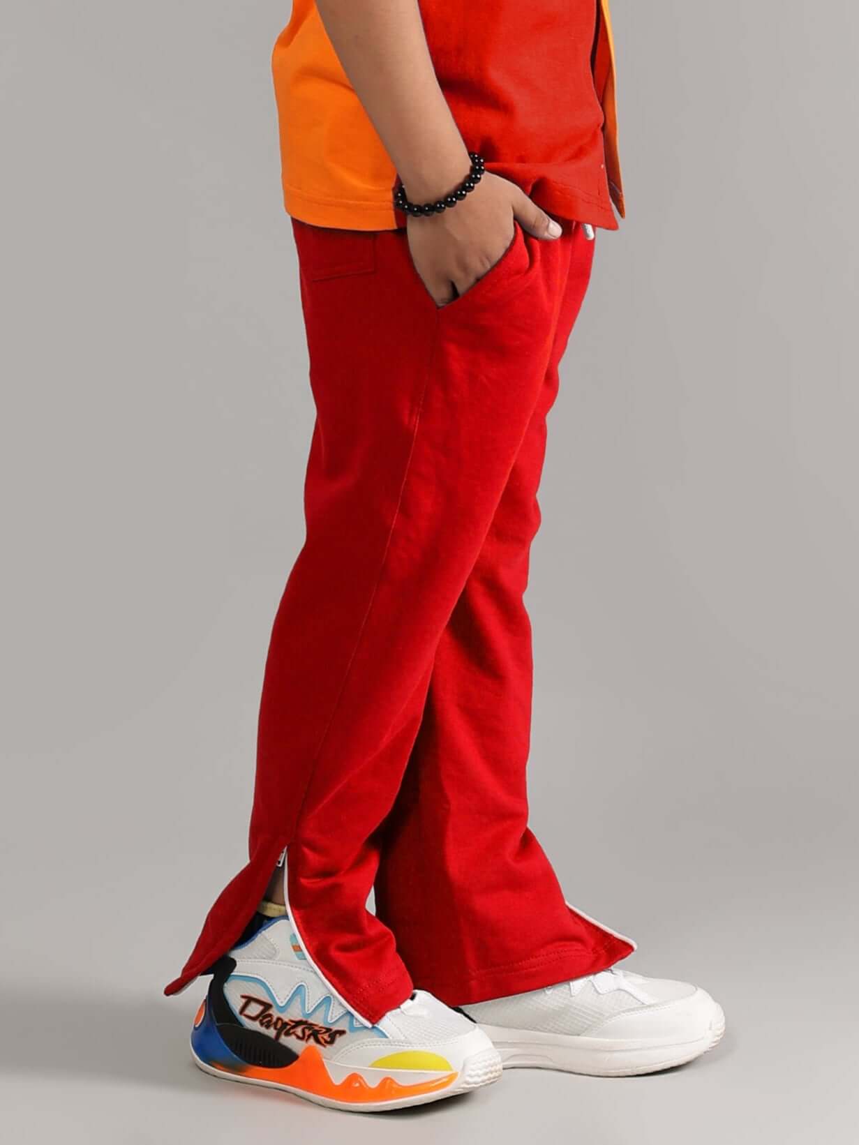Child wearing HERSHEY JOGGER FOR BOYS & GIRLS RED with vibrant sneakers, illustrating comfortable fit and style.