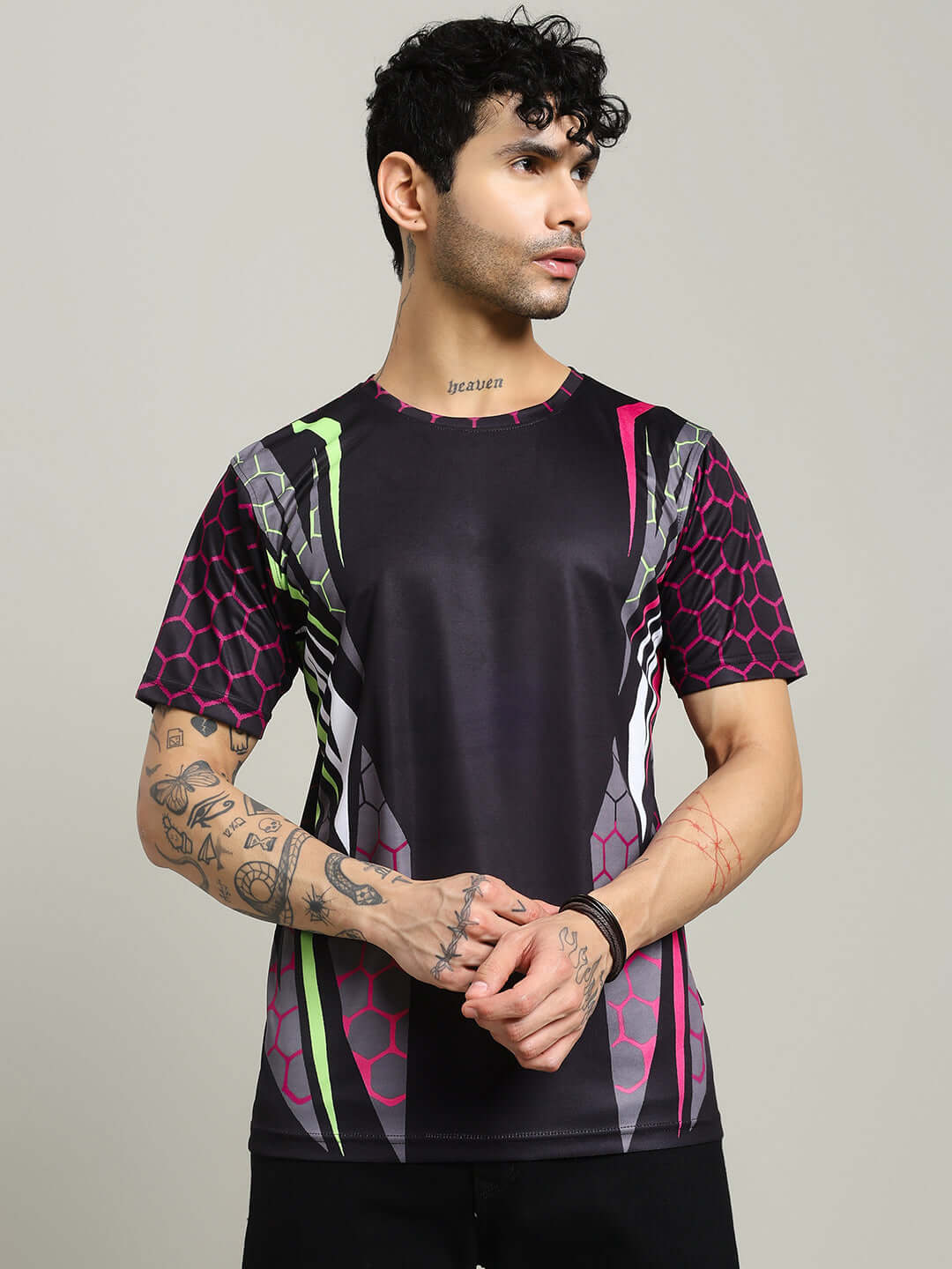 Model wearing black hexagon printed regular fit t-shirt made of sports polyester fabric, designed by Color By Colours.