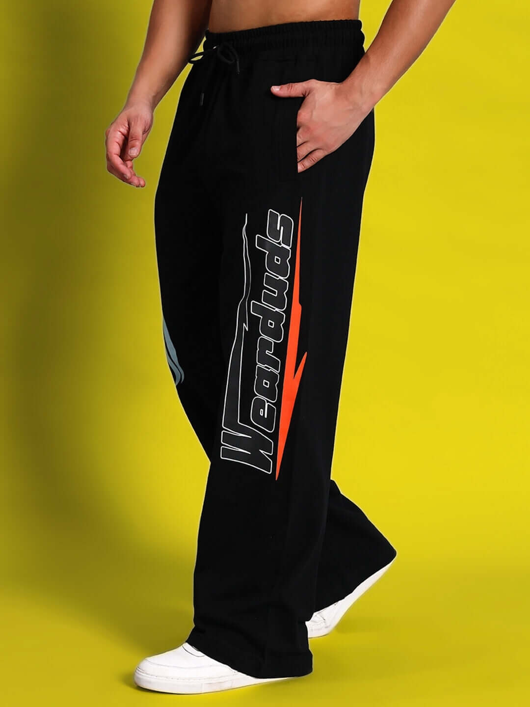 Model wearing HI-SPEED Relaxed Fit Jogger in Black by DUDS, featuring custom fit option and branding on leg, set against yellow background.
