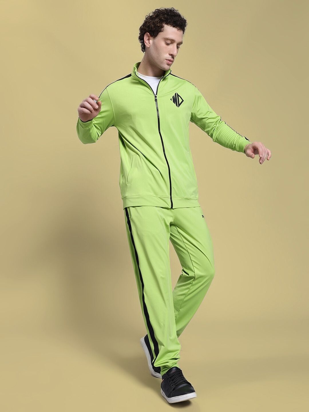 Man wearing HIGH PERFORMANCE CO-ORD SET NEON GREEN with zip-up hoodie and joggers, showcasing athleisure style.