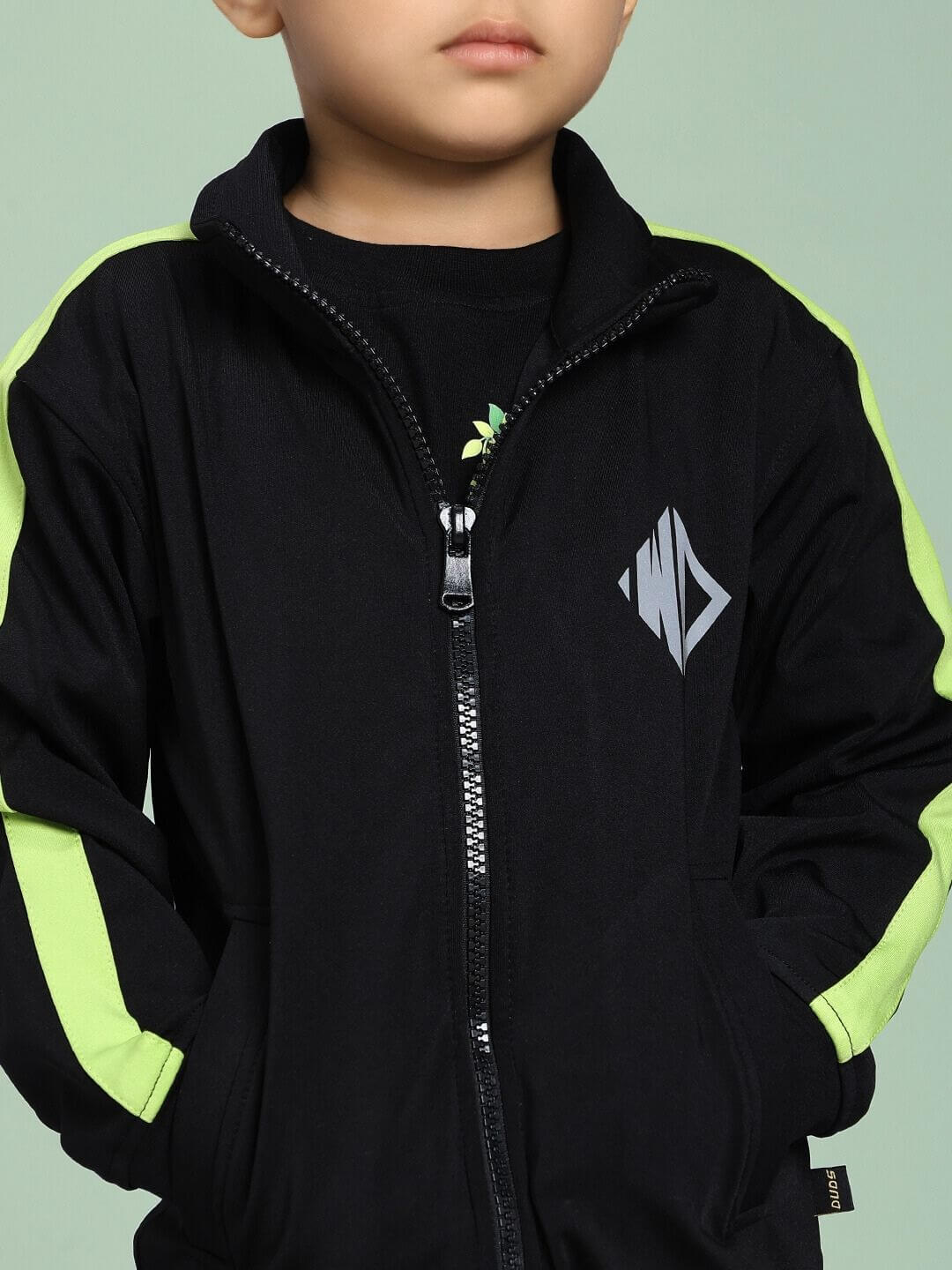 Child wearing High Performance Jacket for Boys and Girls Black with green stripes, ideal for all weather and activities.