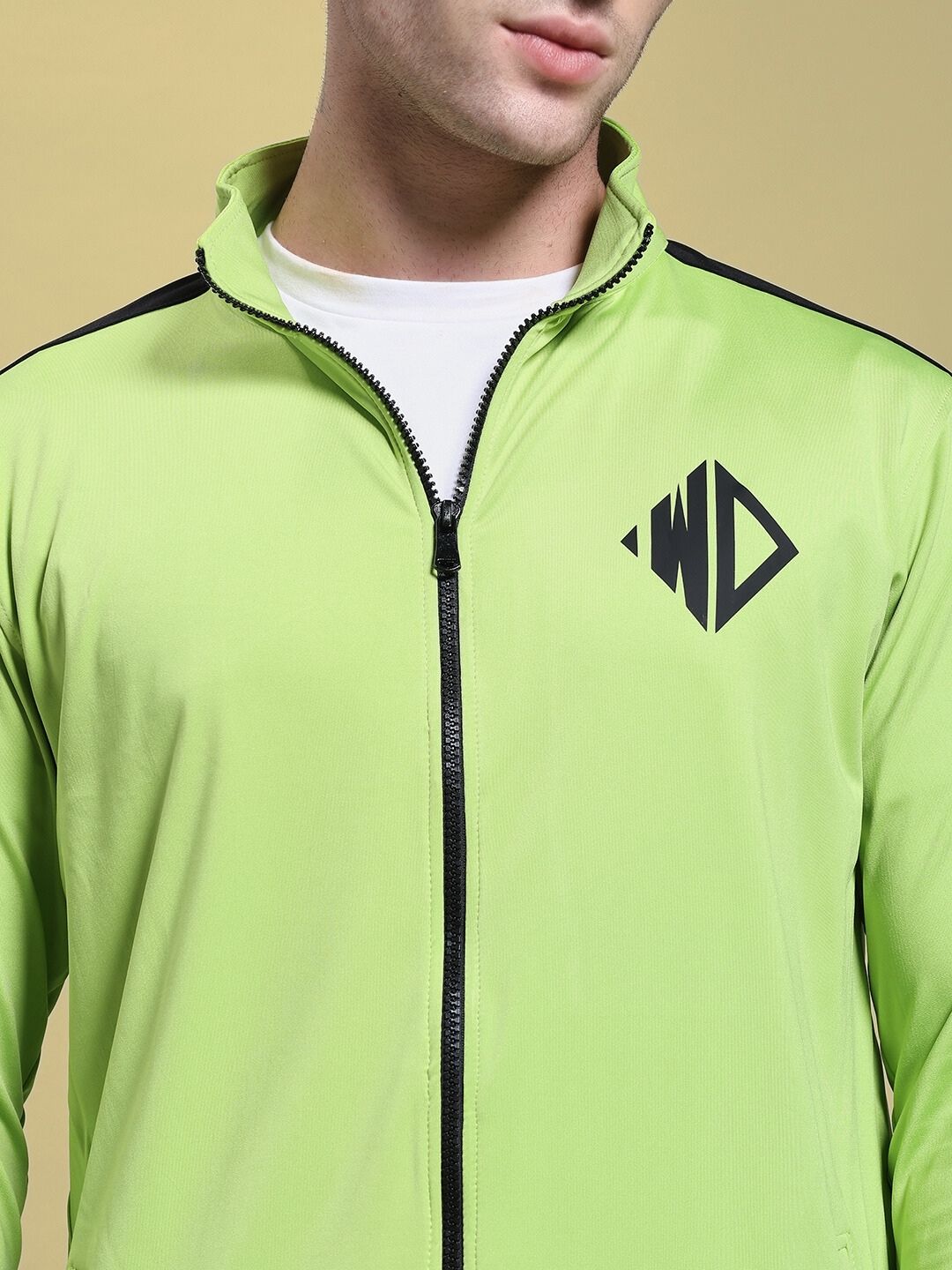 Model wearing HIGH PERFORMANCE JACKET NEON GREEN with zipper and logo design, ideal for athletes and urban explorers.