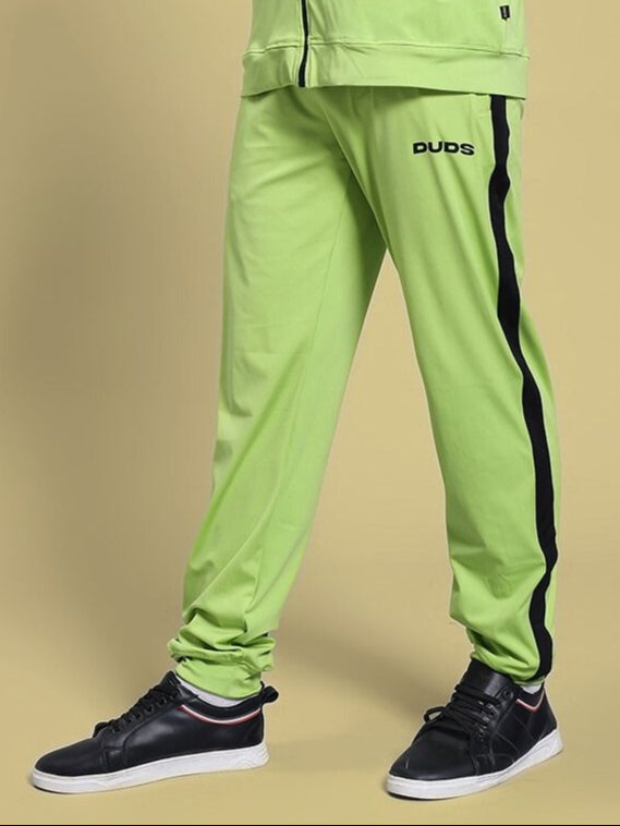 Person wearing HIGH PERFORMANCE RELAXED FIT JOGGER NEON GREEN with black shoes on a neutral background.